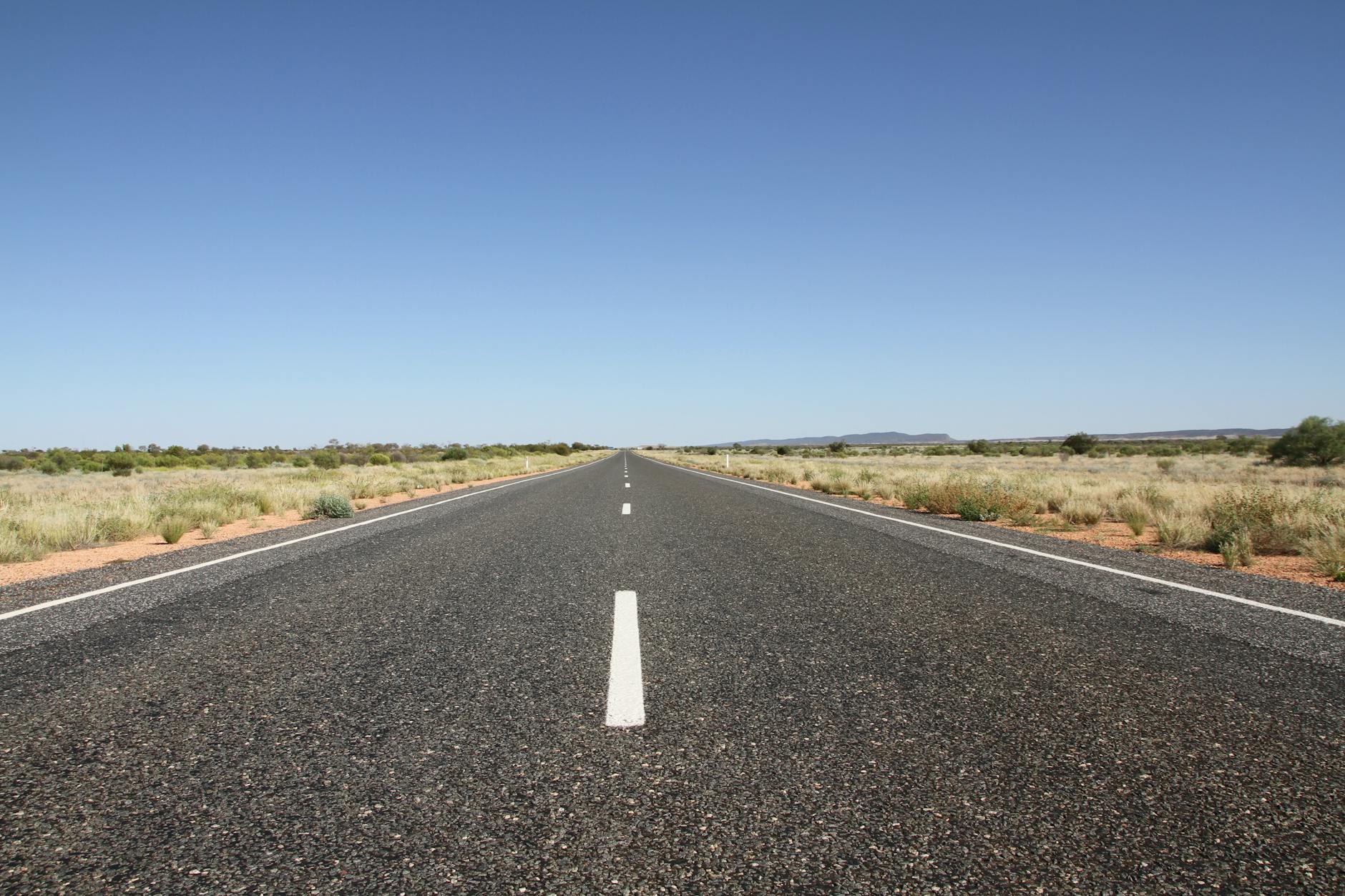 Long straight road through the Australian outback.