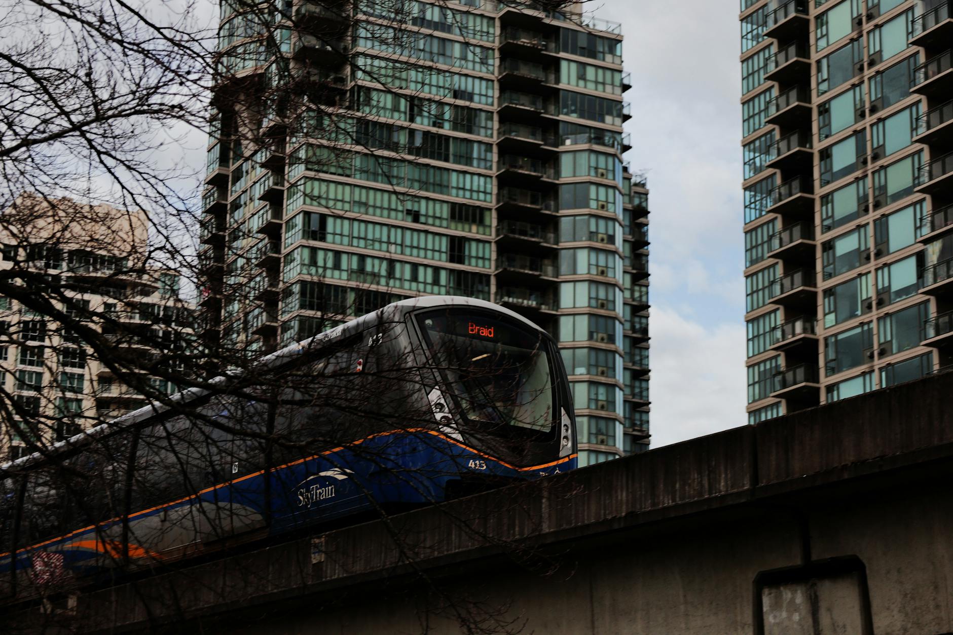 SkyTrain moving through Vancouver high-rises.