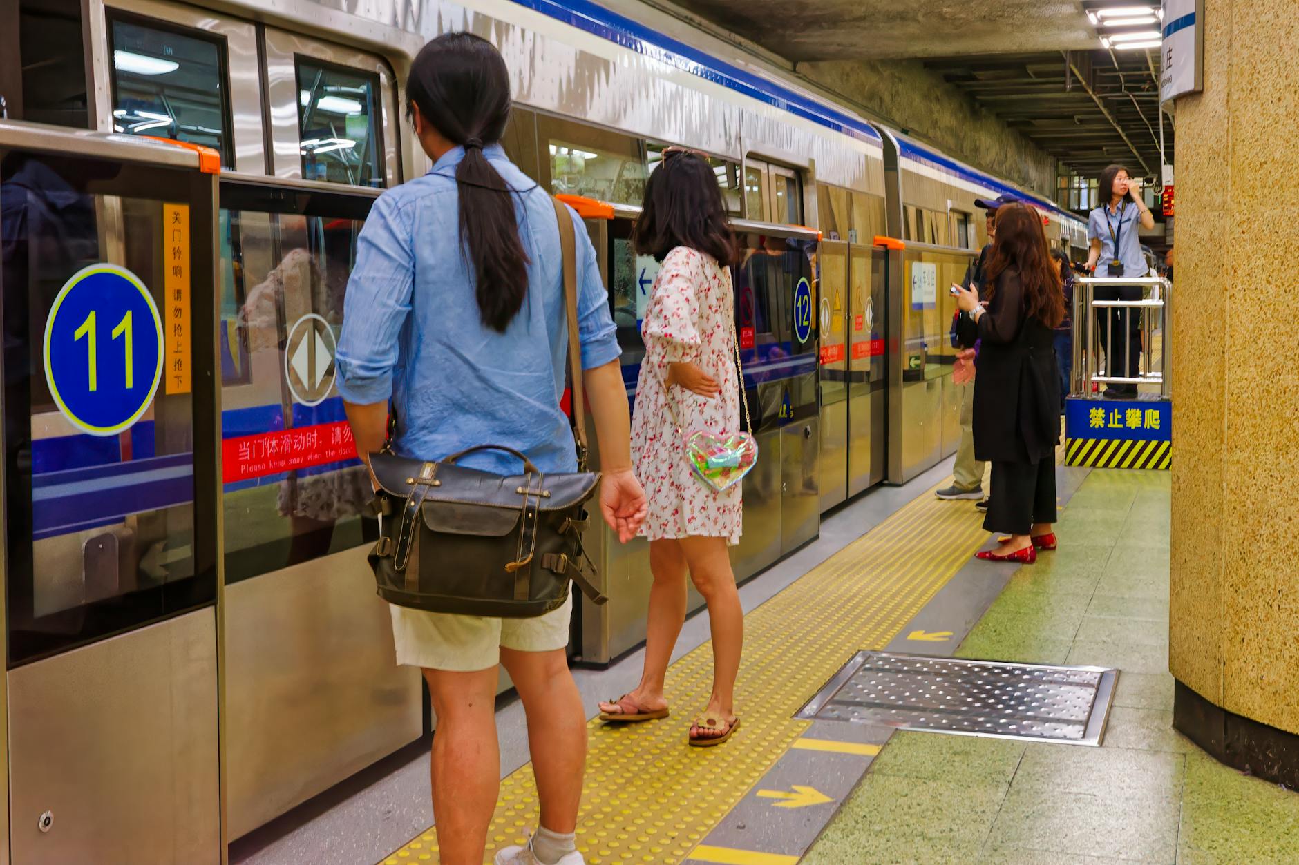 Commuters waiting at a Beijing subway platform.