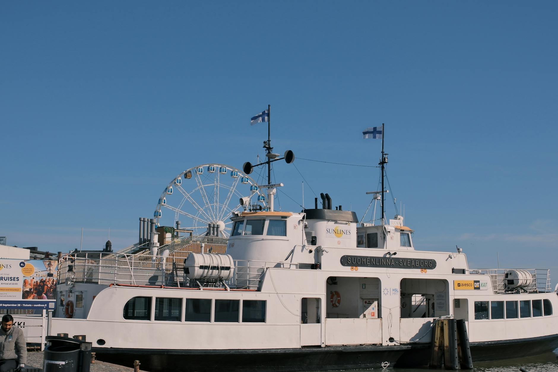 Ferry at Helsinki harbor under clear skies.
