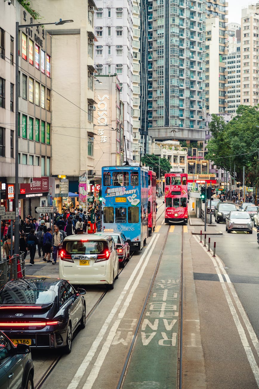 Busy Hong Kong Island street with trams and traffic.