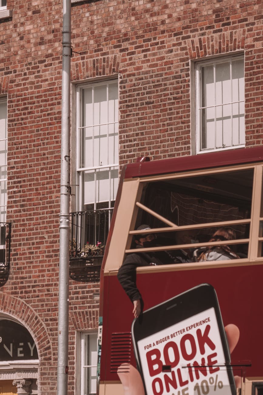 Classic Dublin bus passing Georgian buildings.