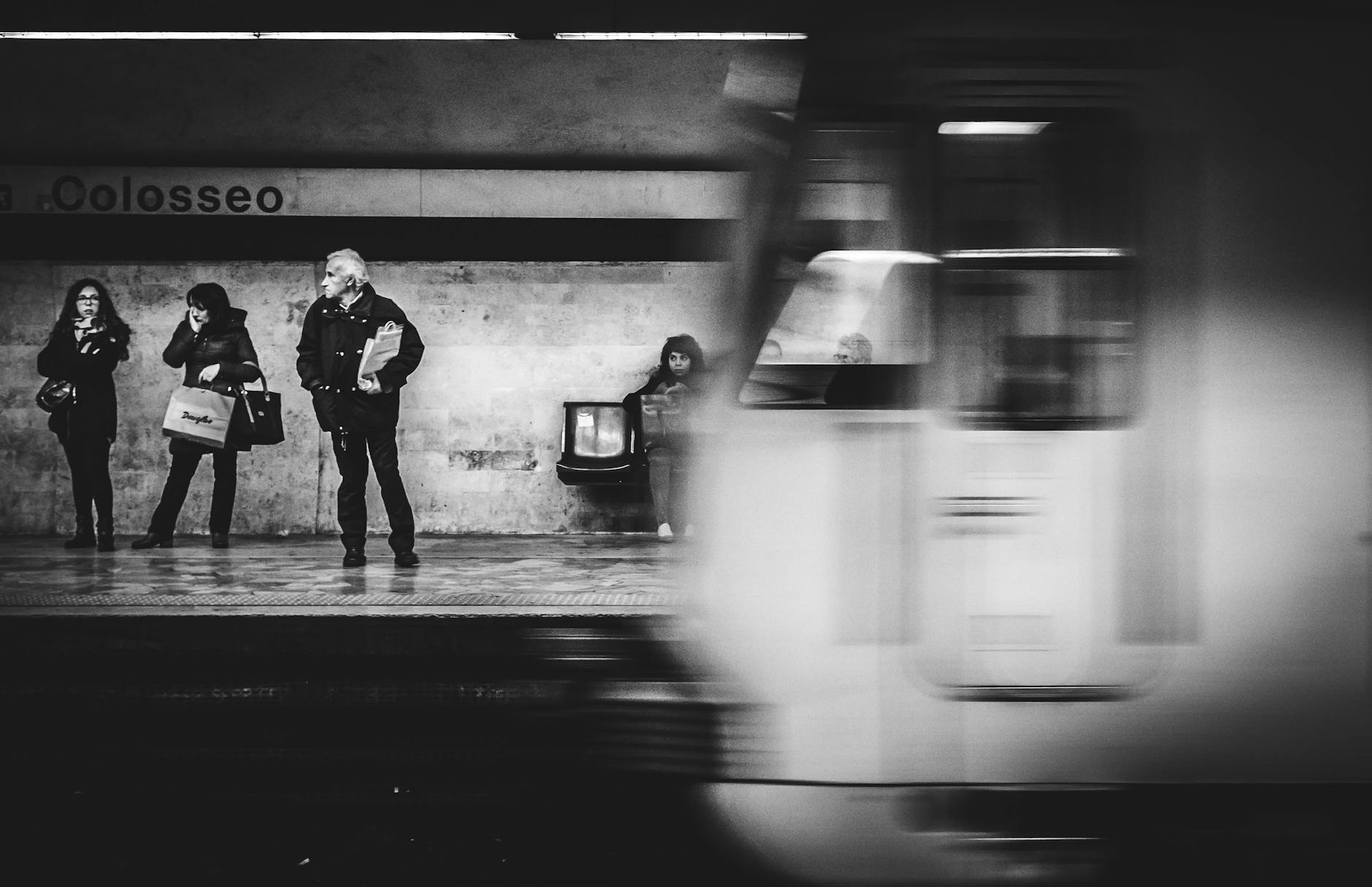 Passengers waiting at Colosseo Metro Station in Rome.