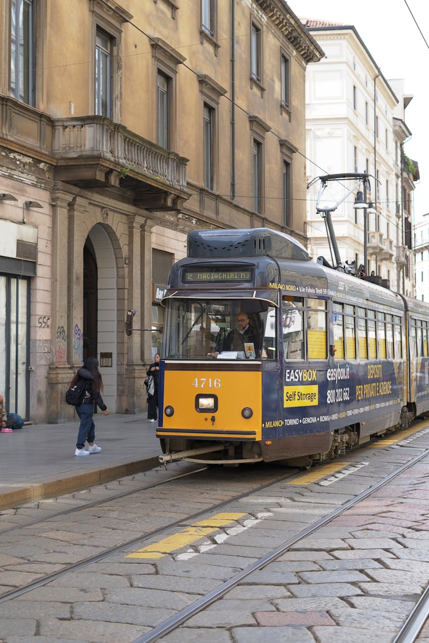 Classic yellow tram on a Milan street.