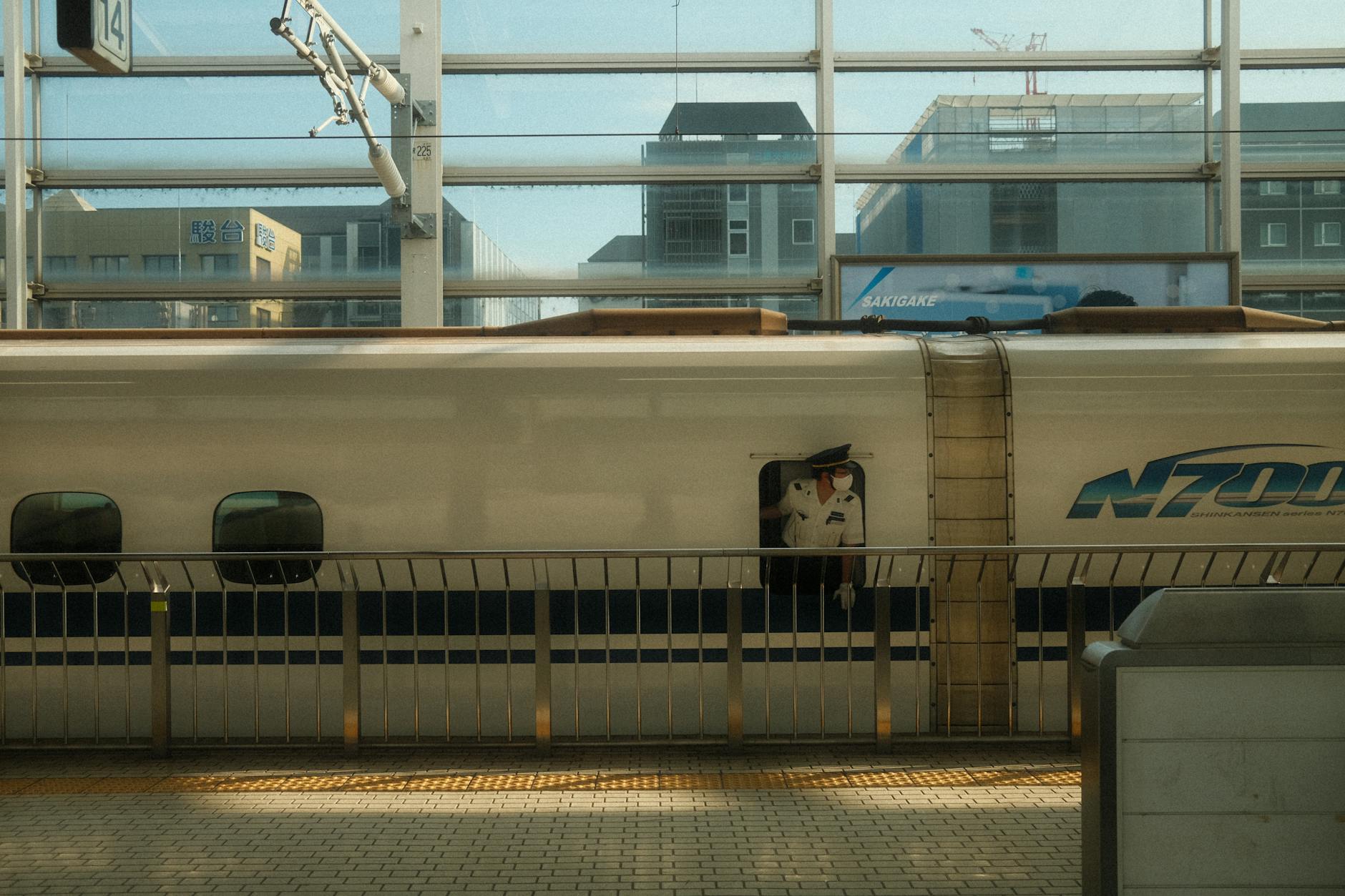 N700 Shinkansen with conductor at Tokyo Station.
