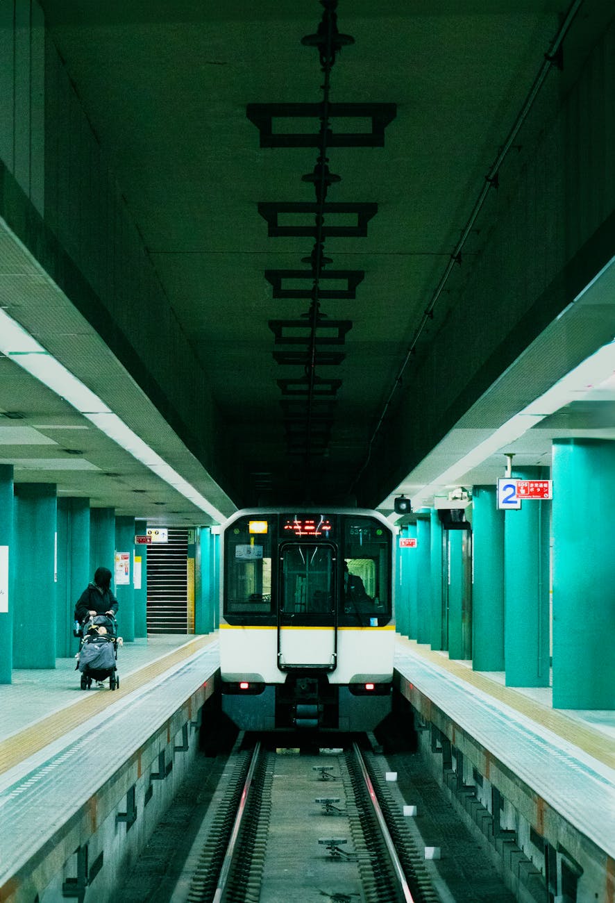 Subway train approaching a Tokyo station platform.