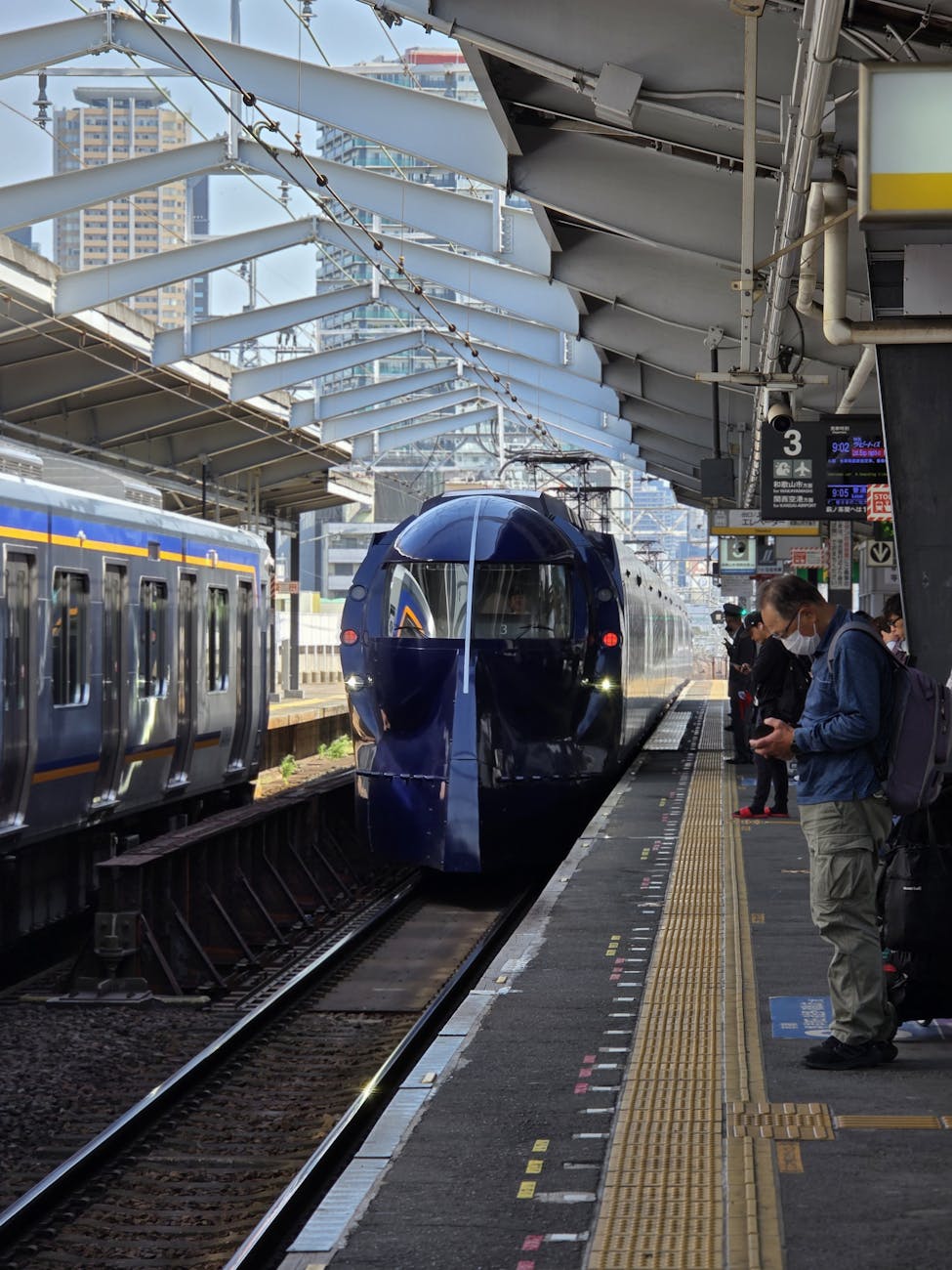 Modern train arriving at Osaka Station.