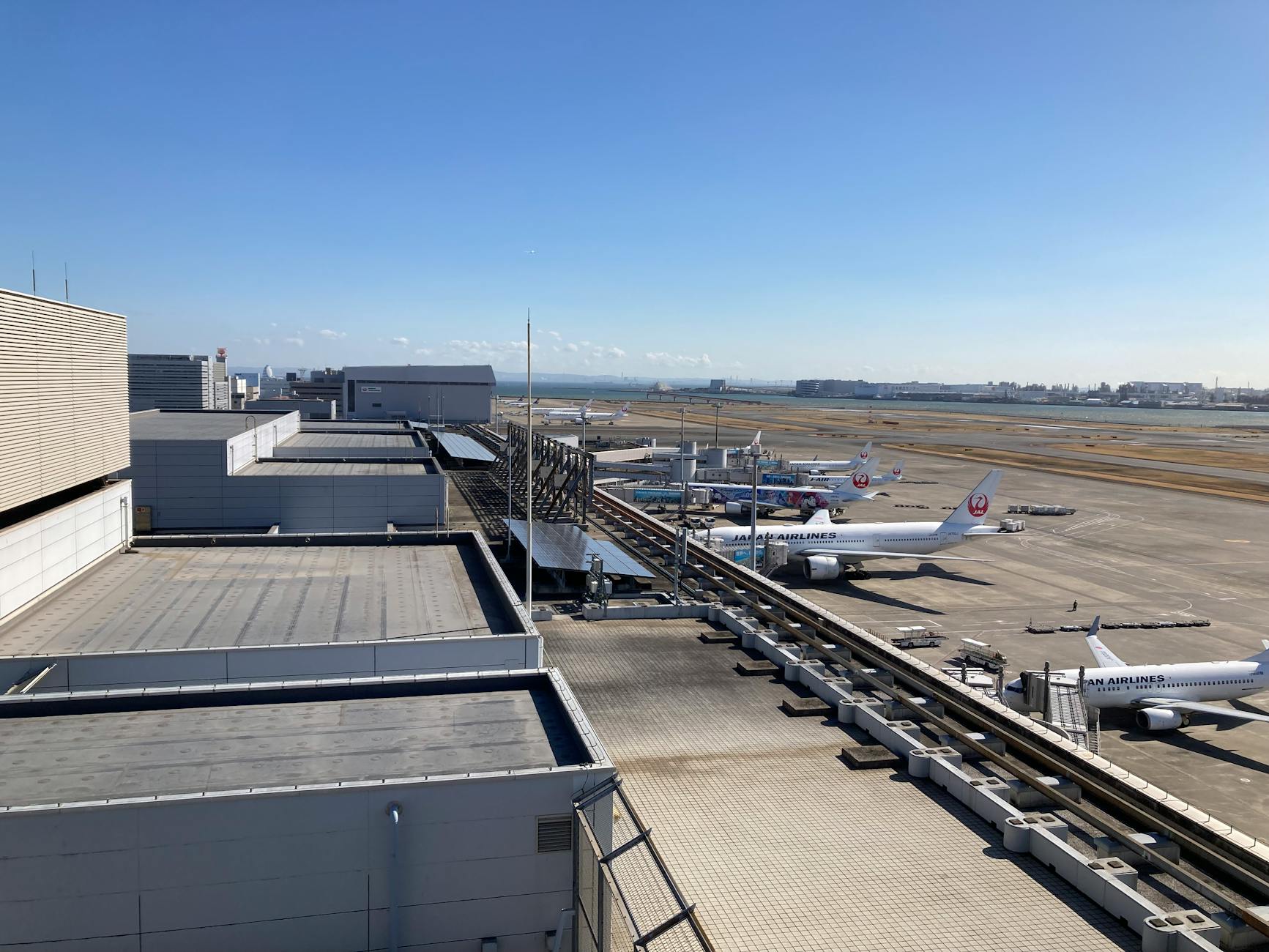 Aerial view of Haneda Airport aircraft at terminal gates.