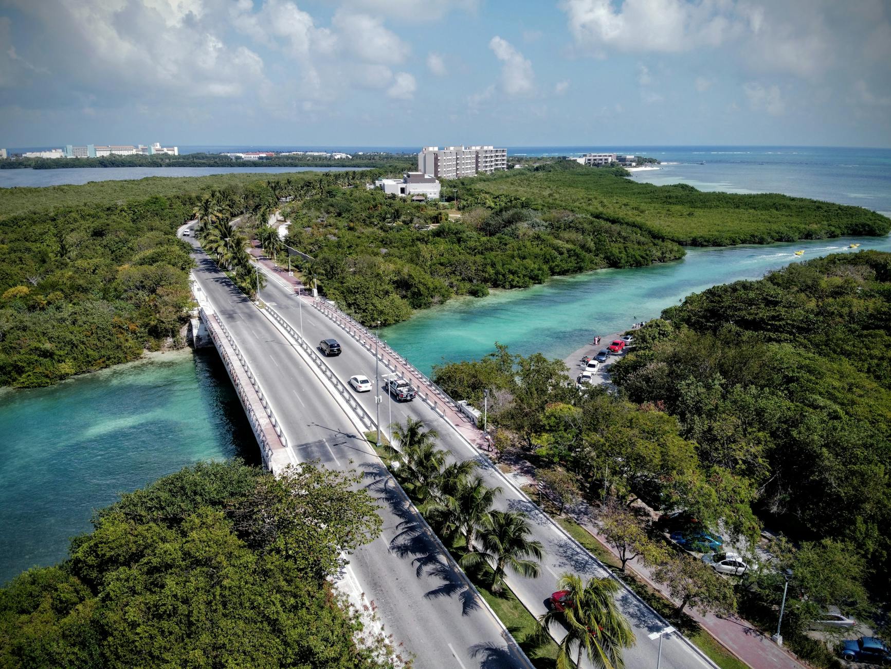 Road bridge crossing turquoise water near Cancun.