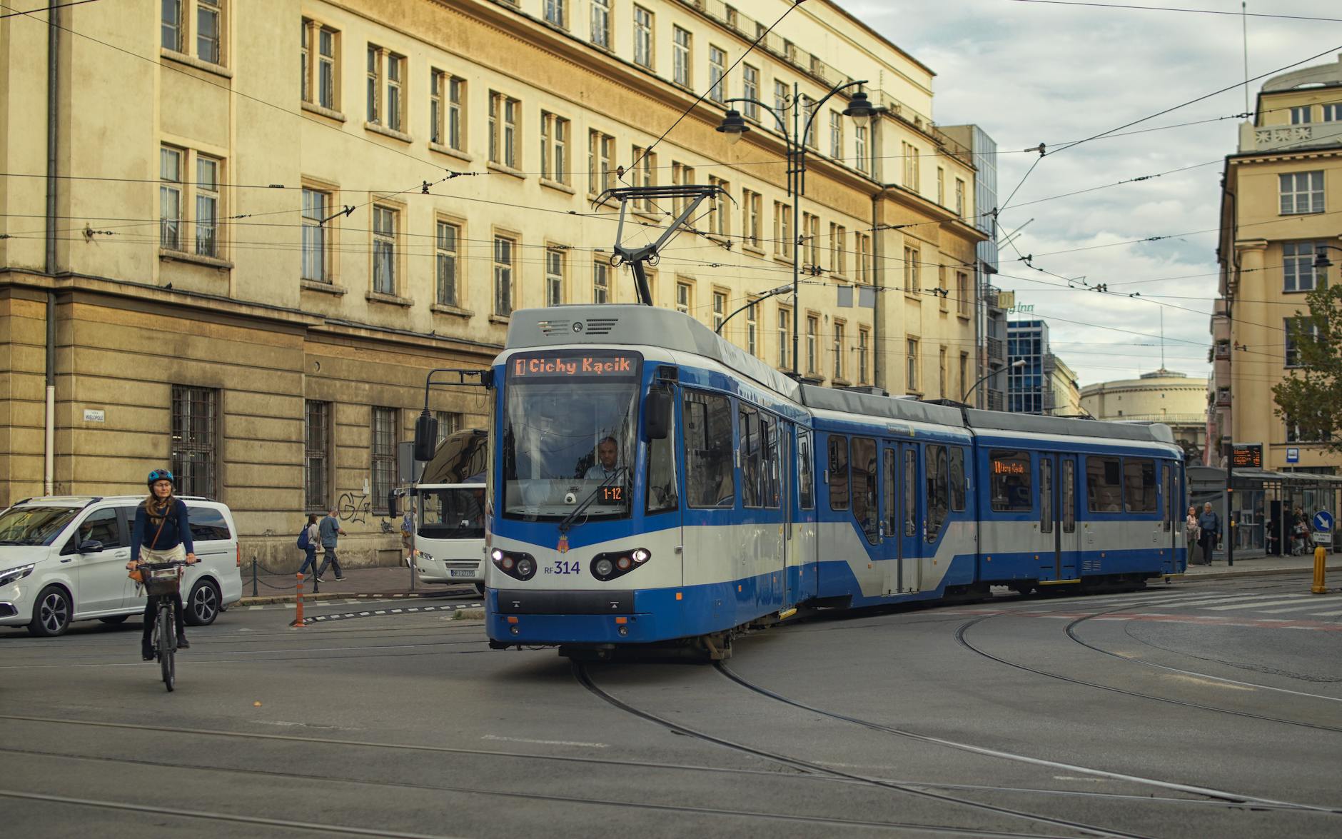 Blue tram moving through central Krakow.