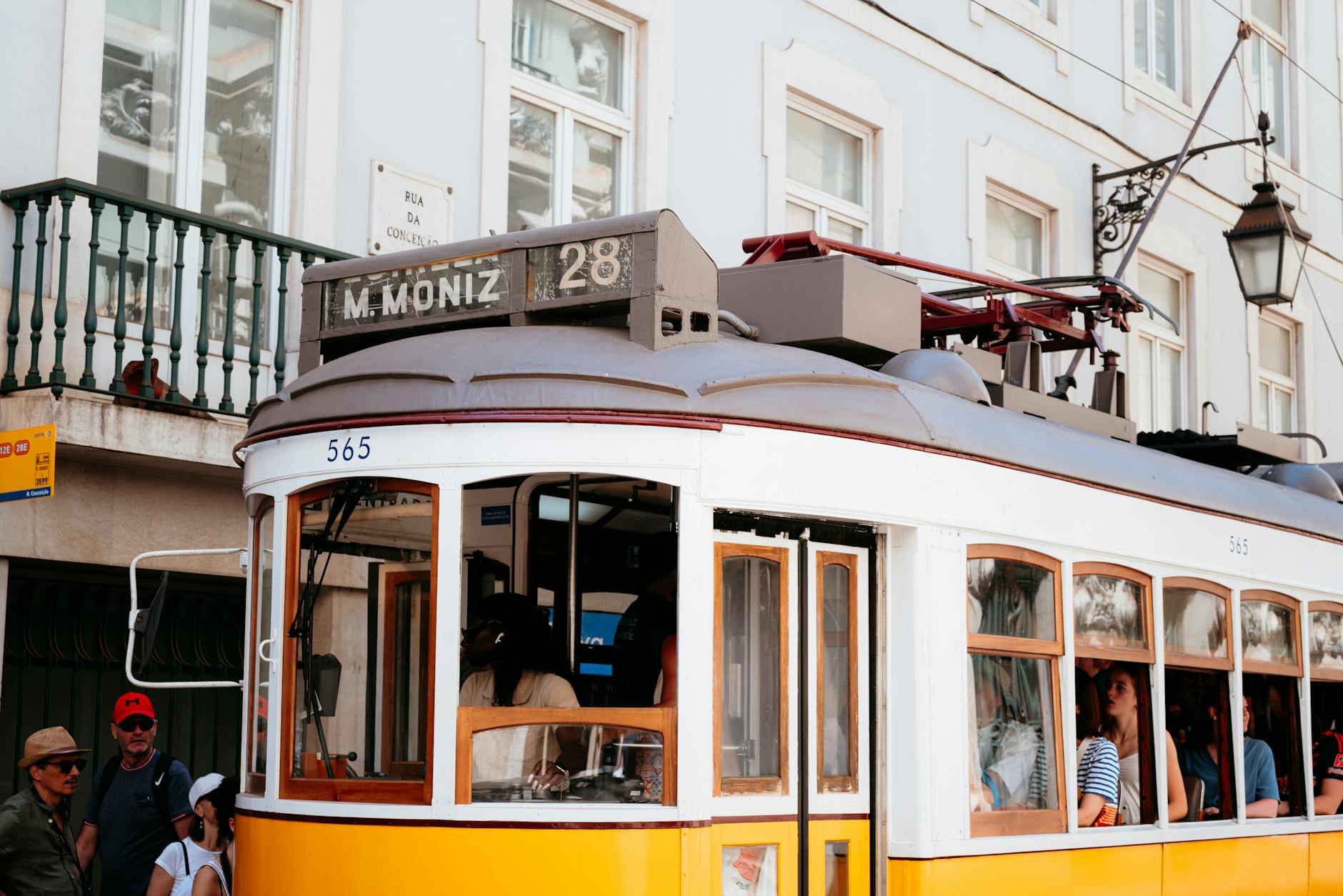 Classic Lisbon tram on a neighborhood street.