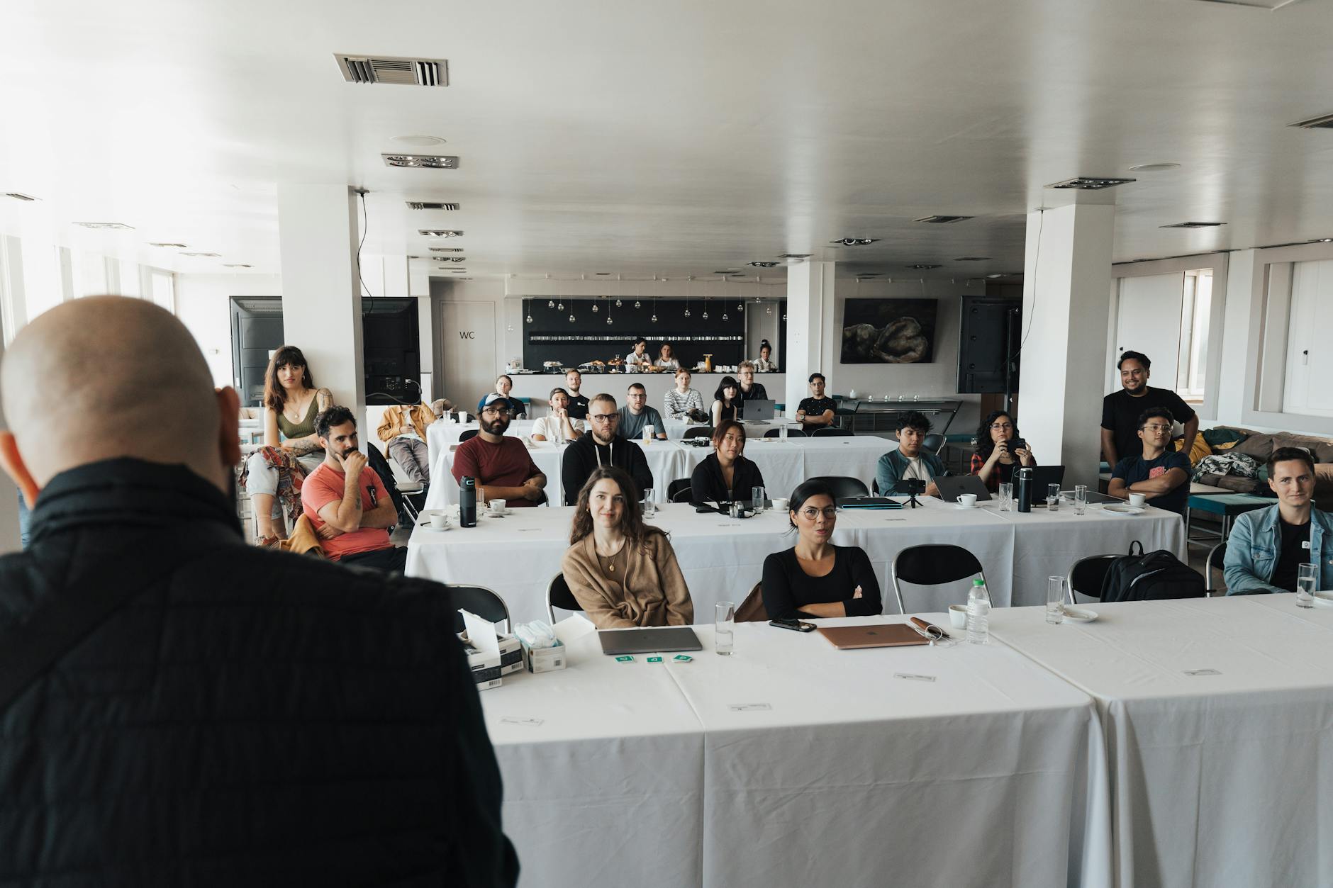 A diverse group of business professionals attending a presentation in a modern conference room.