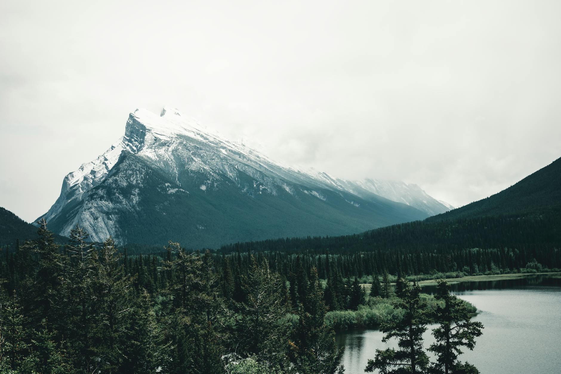 Majestic view of Mount Rundle and serene water in Banff National Park, Alberta, Canada.