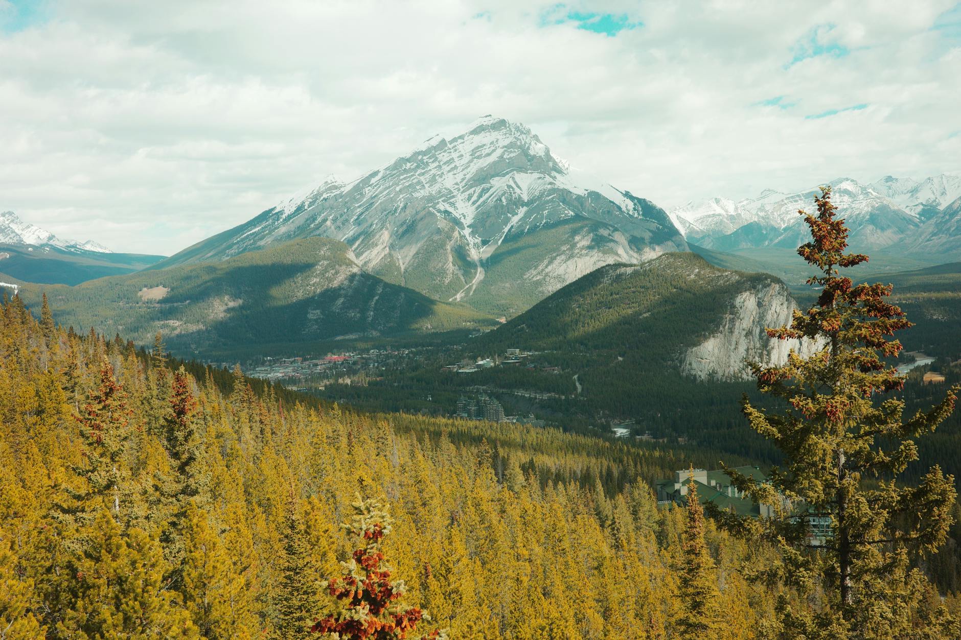 Explore the breathtaking landscape of Banff National Park with towering mountains and lush forests.