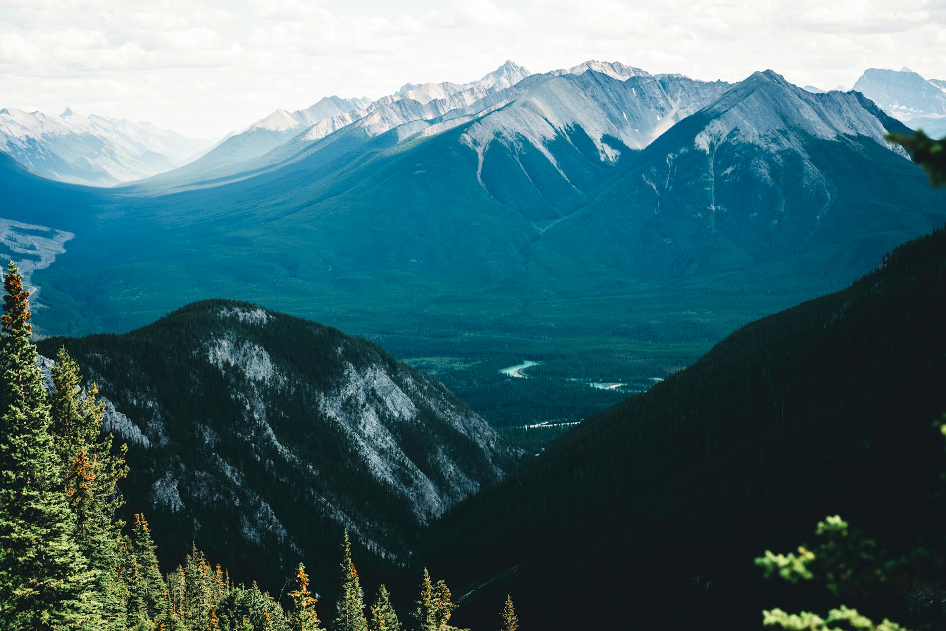 Breathtaking view of the Rocky Mountains in Banff, showcasing lush valleys and rugged peaks.