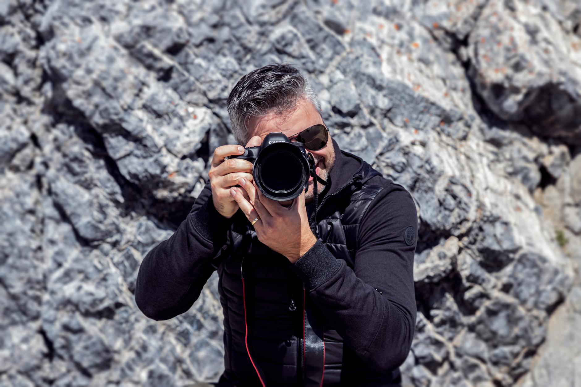Dynamic shot of a photographer capturing nature in Banff, Canada, showcasing professional photography gear.