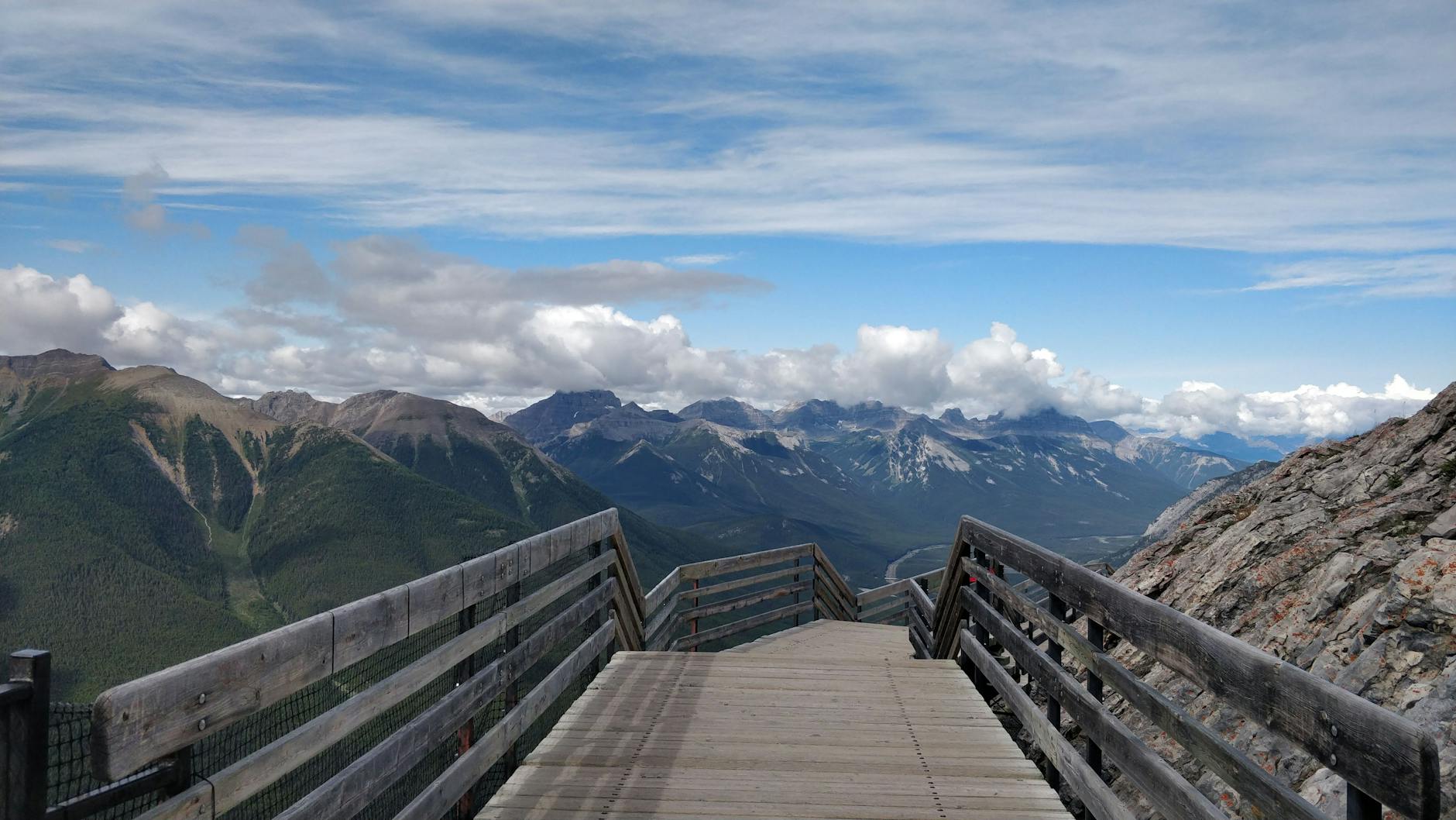 Majestic mountain view from a wooden boardwalk in Banff, Canada.