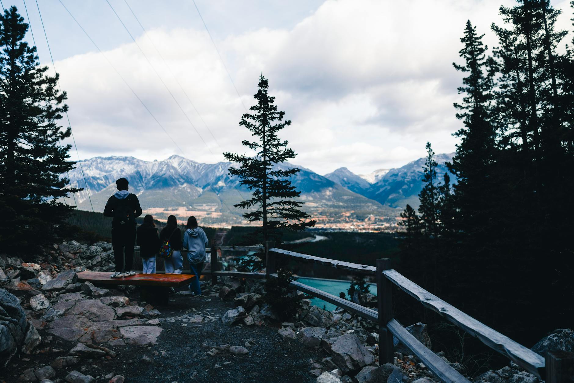Group enjoying majestic mountain view from a lookout in Canadian wilderness, perfect for adventure and travel themes.