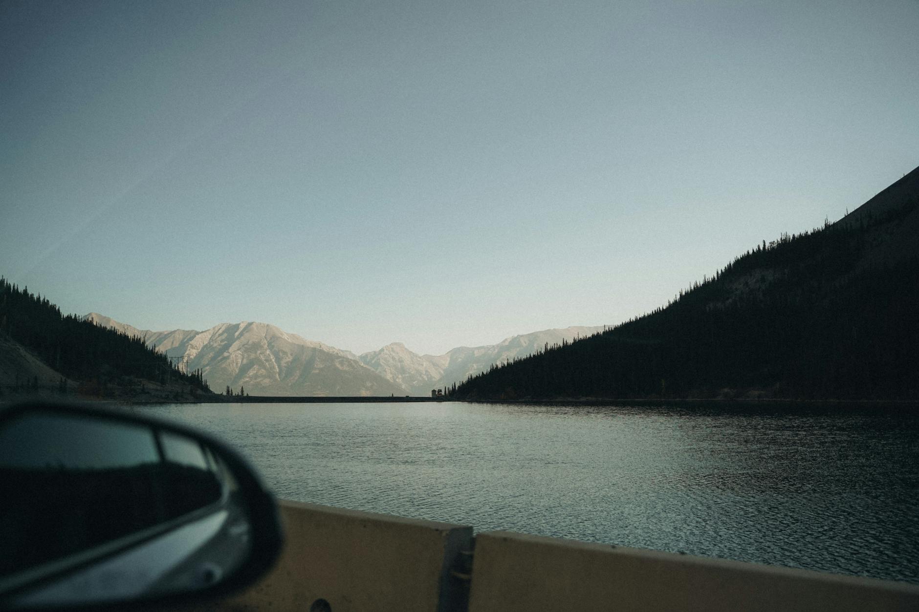 Majestic lake and mountain view in Banff, Canada, captured from a car perspective.