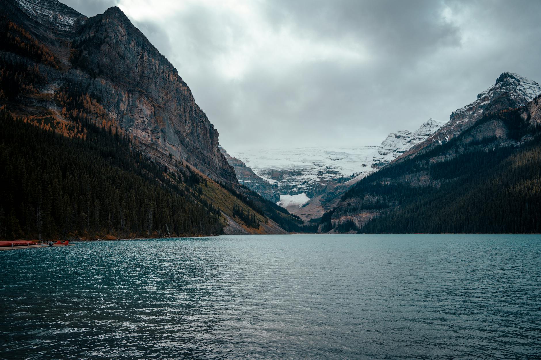 Majestic view of Lake Louise surrounded by snow-capped mountains in Banff National Park.