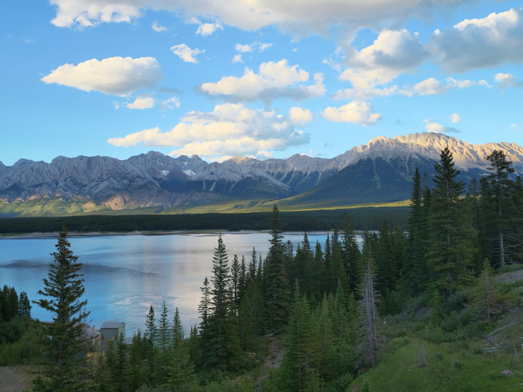 Beautiful summer view of the Rocky Mountains overlooking a serene lake.