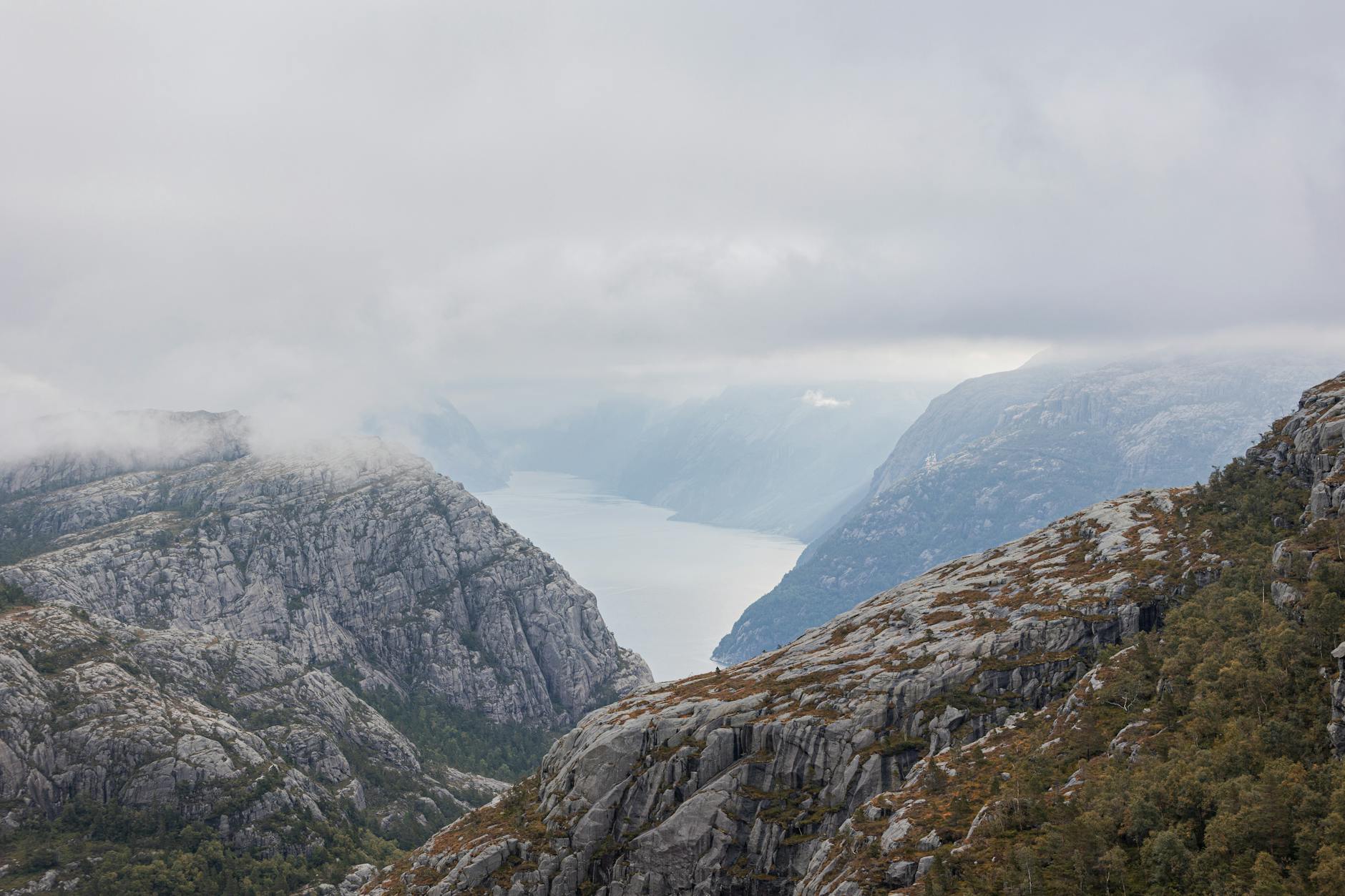 Misty Norwegian fjord and mountains for adventure travel report planning.