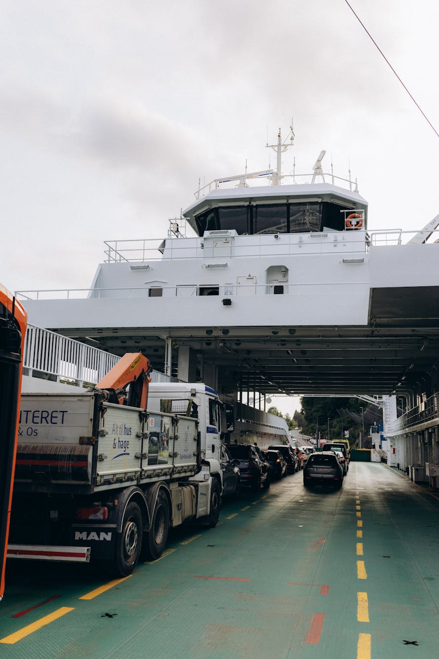 Vehicles boarding a Bergen ferry for excursion and return planning.