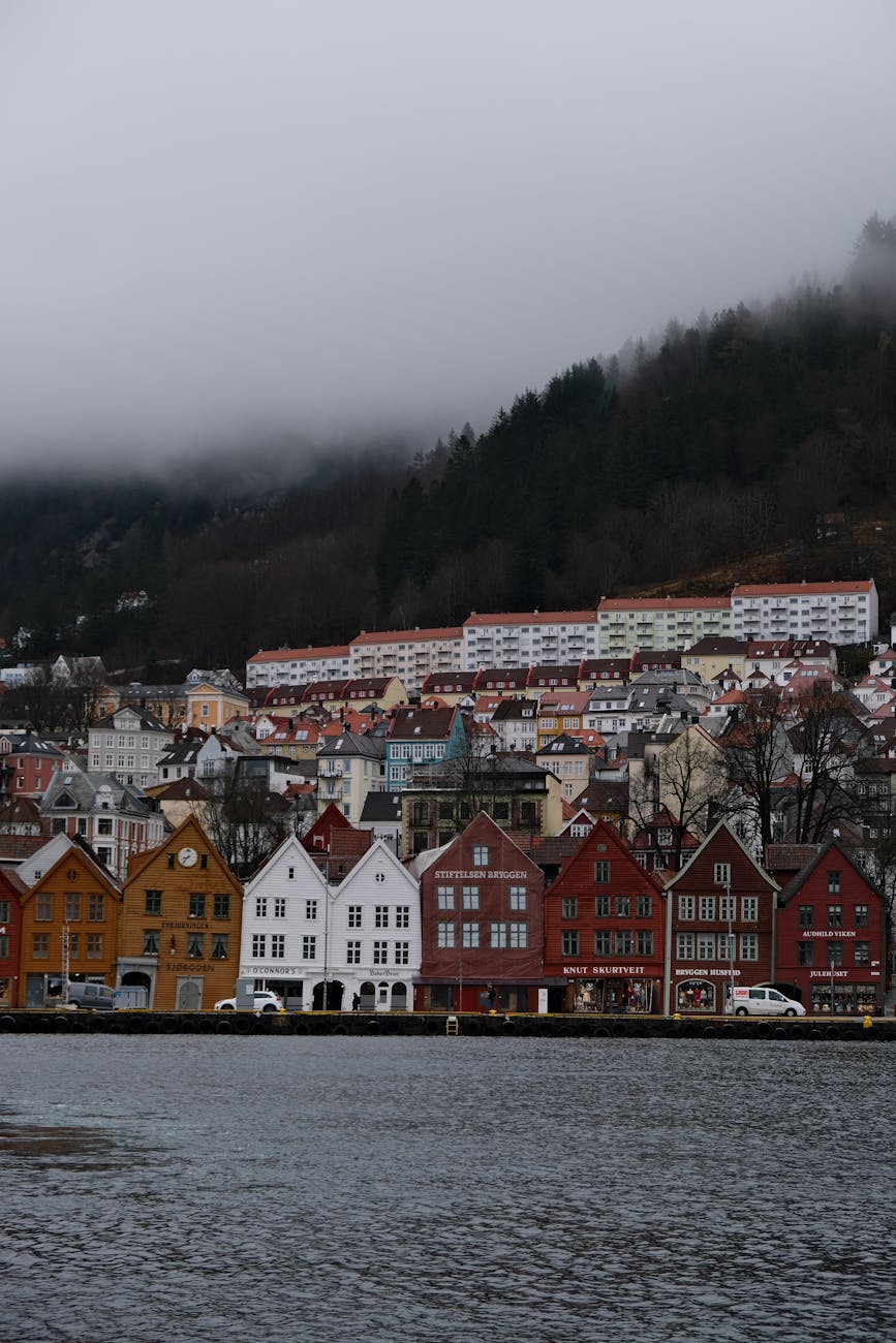 Foggy Bergen waterfront houses for rainy port-call planning.