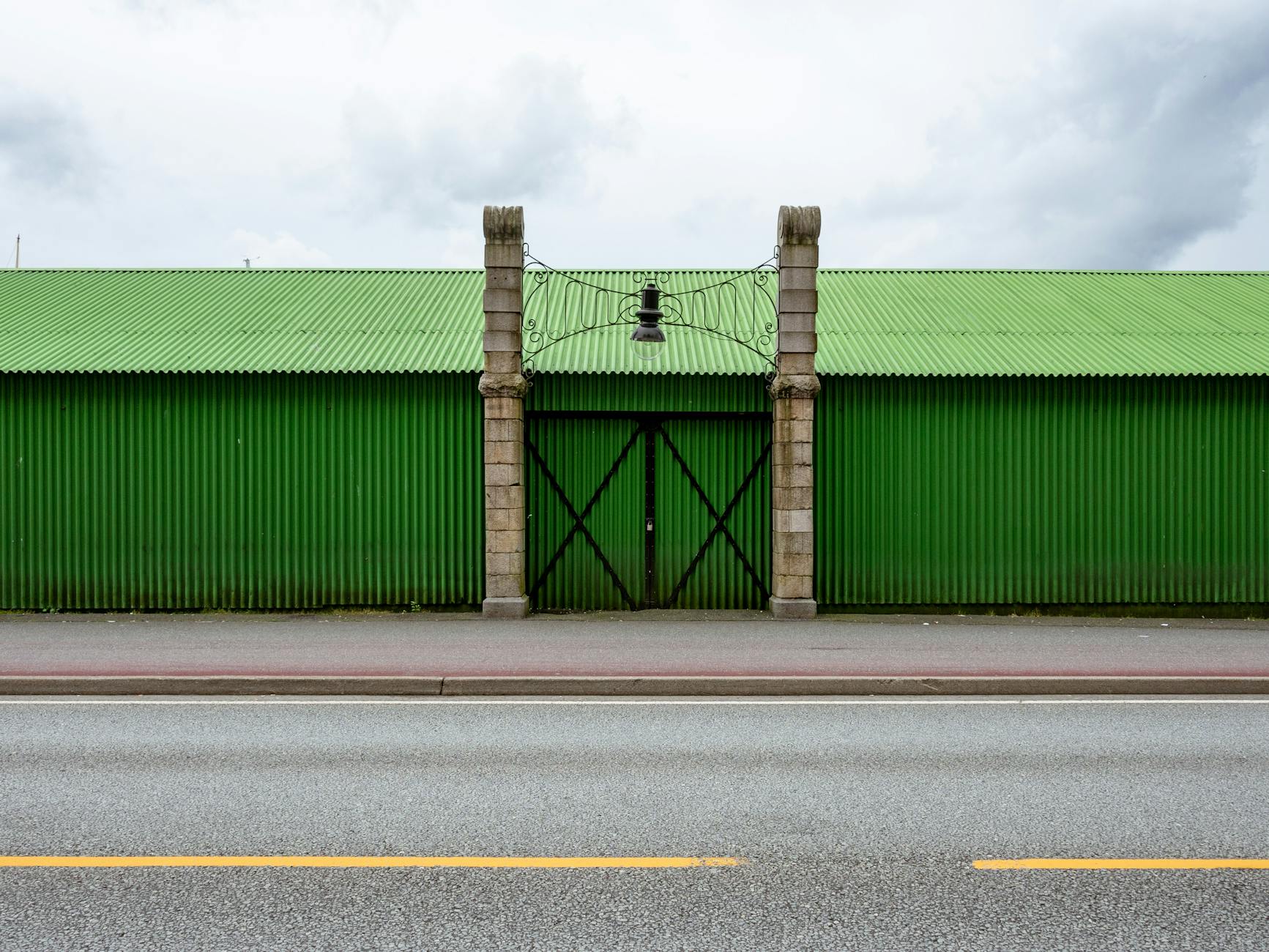 Green warehouse facade in Bergen for journalist filing-base planning.
