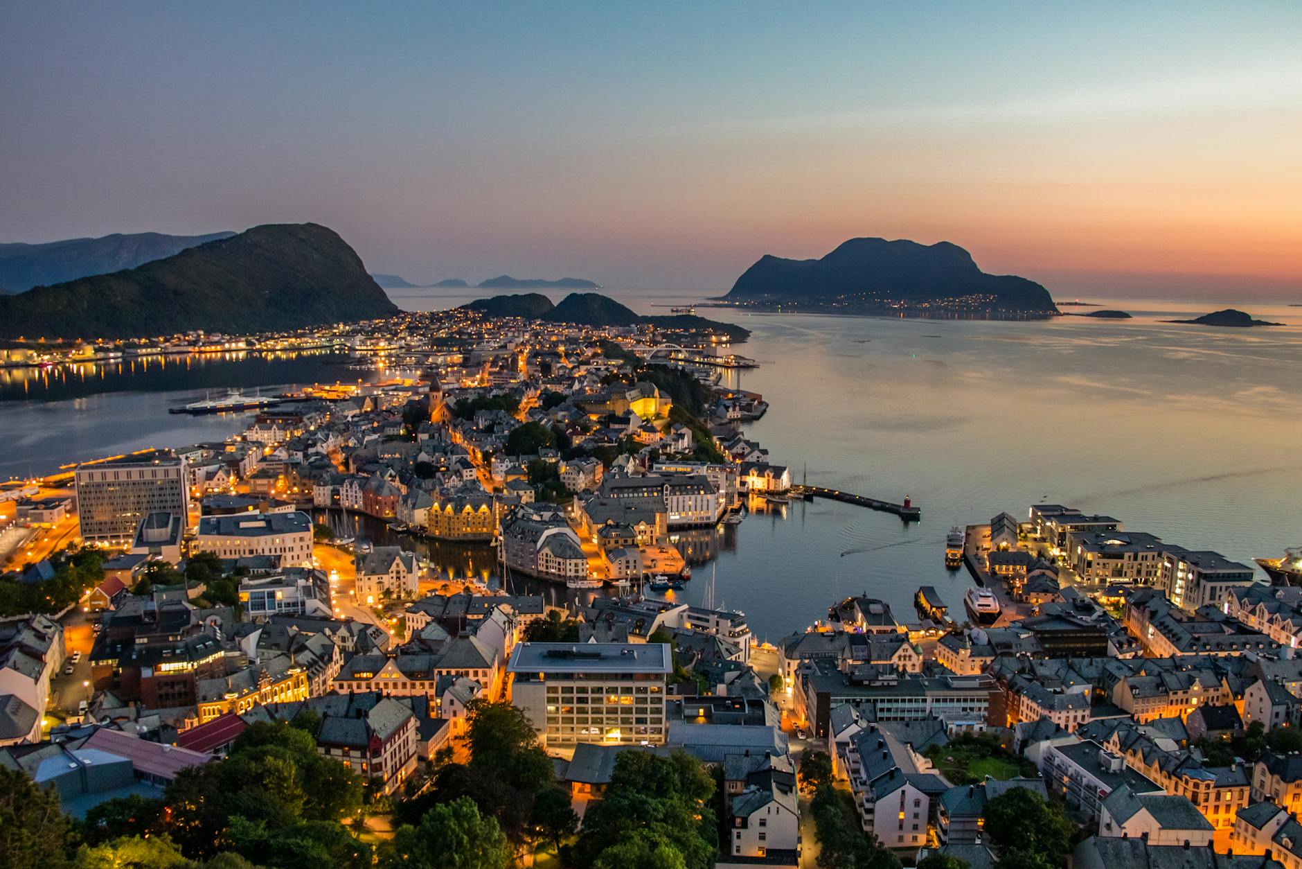 Norwegian harbor skyline at night for nightlife travel report planning.