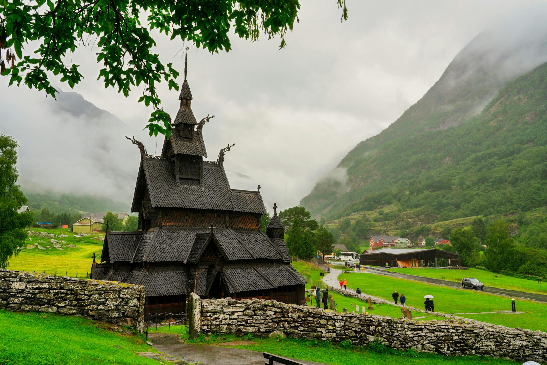 Norwegian stave church in mountain landscape for pilgrimage route planning.