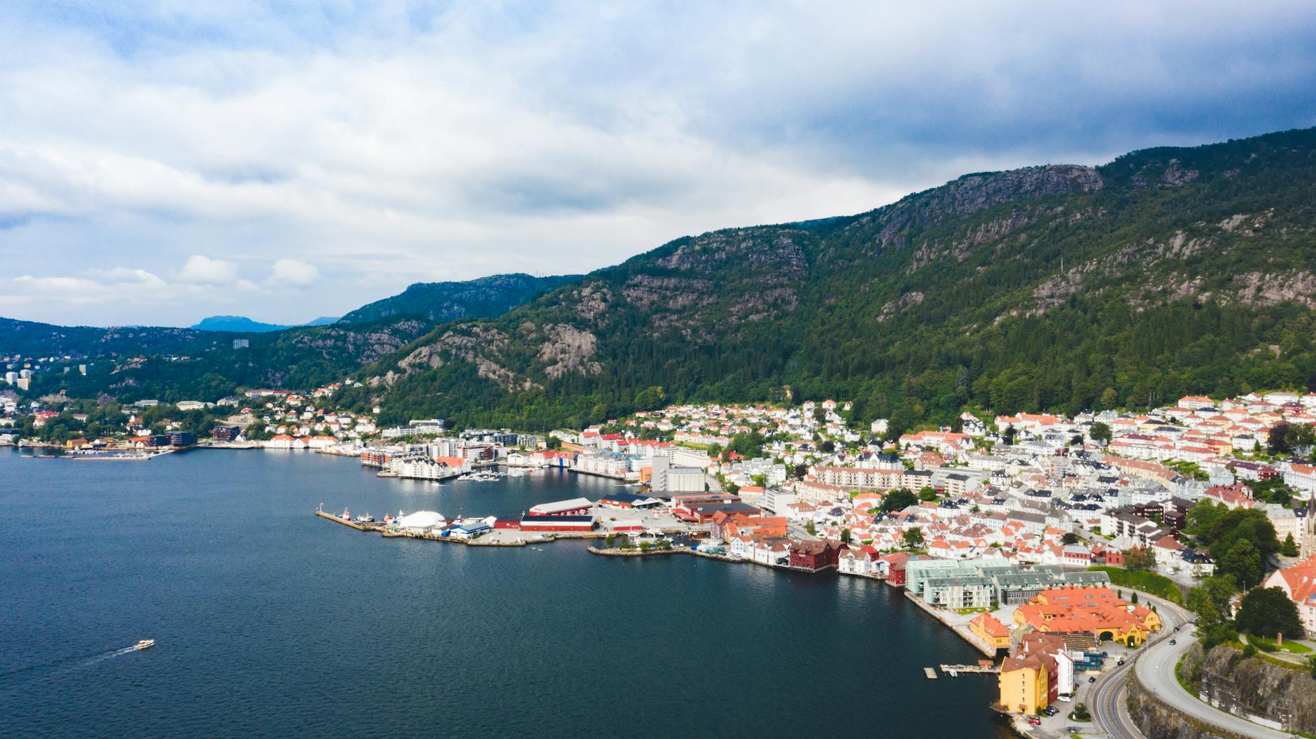 Aerial Bergen waterfront and mountain backdrop for deeper repeat-visit planning.