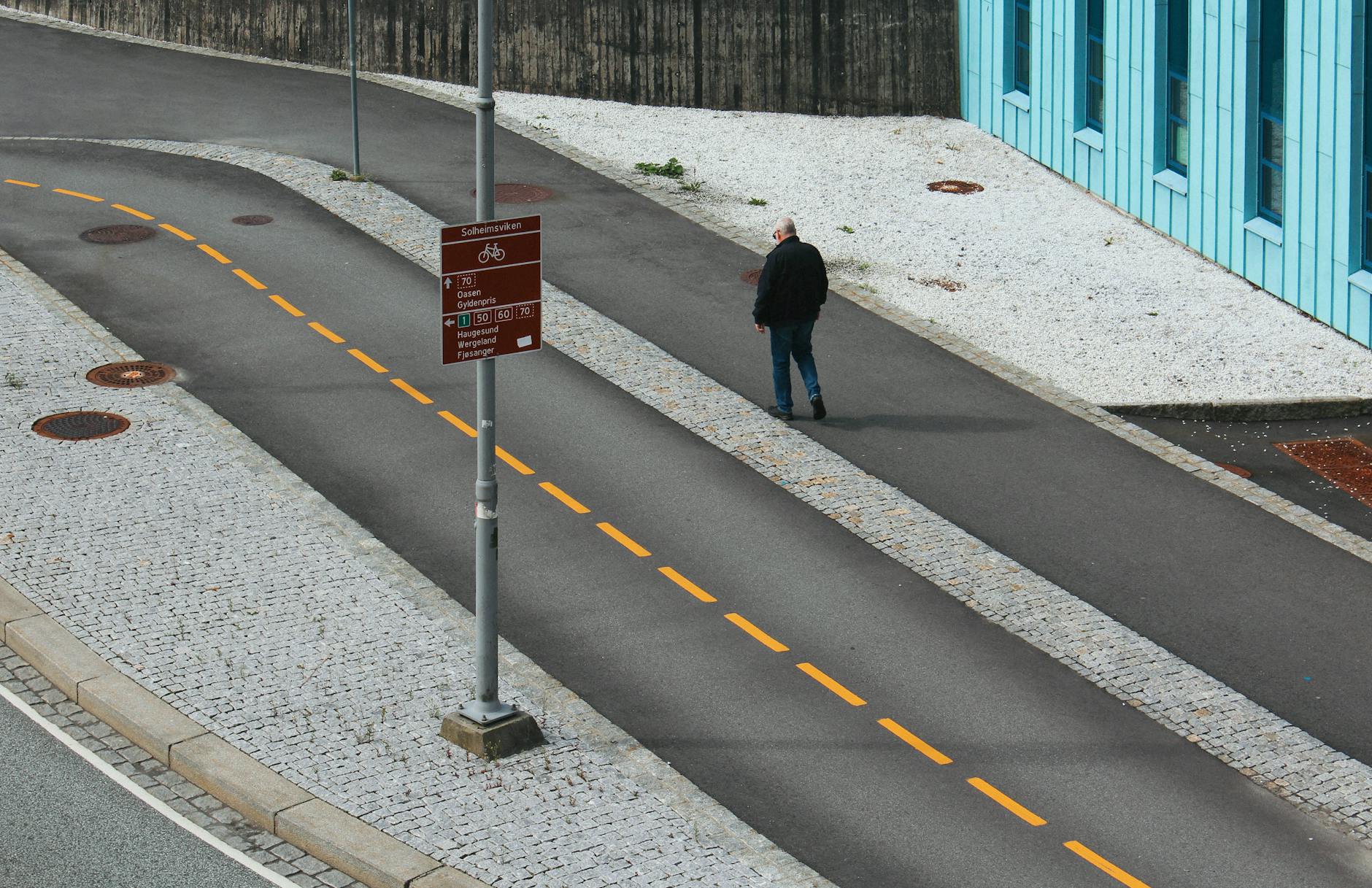 Person walking a Bergen street for solo route planning.