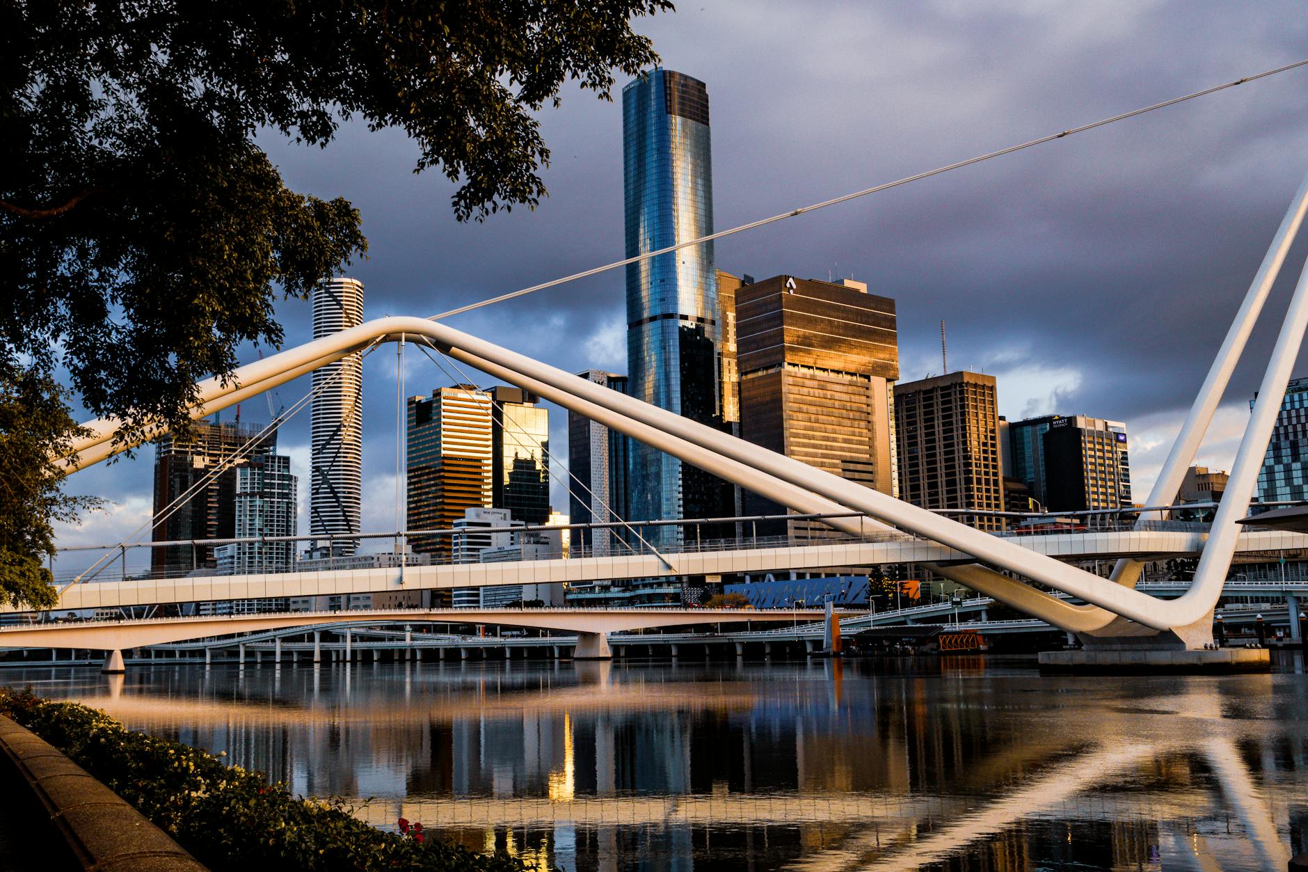 Brisbane bridge and skyline at sunrise for weather-aware conference movement.