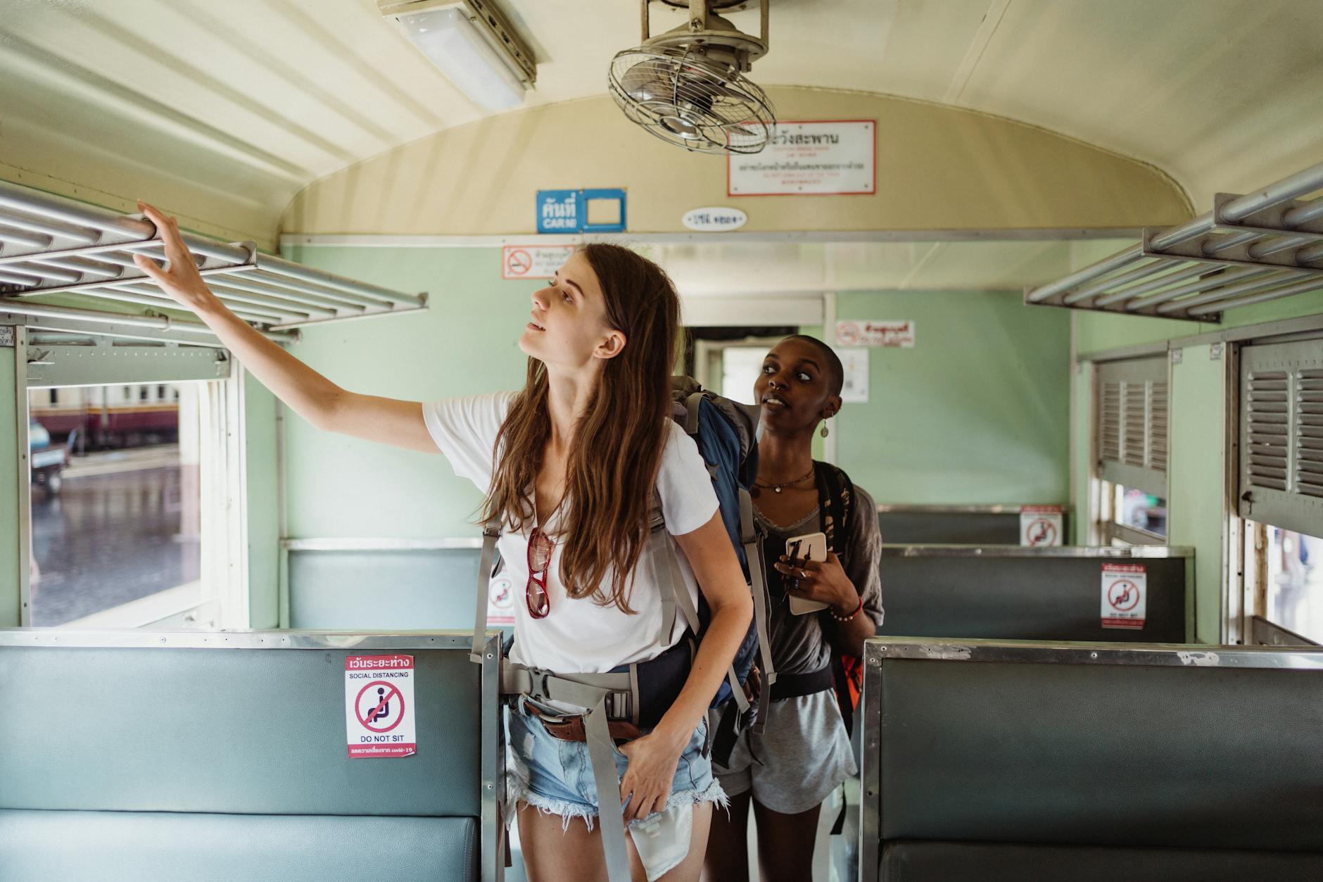 Backpackers on a train for budget movement planning.