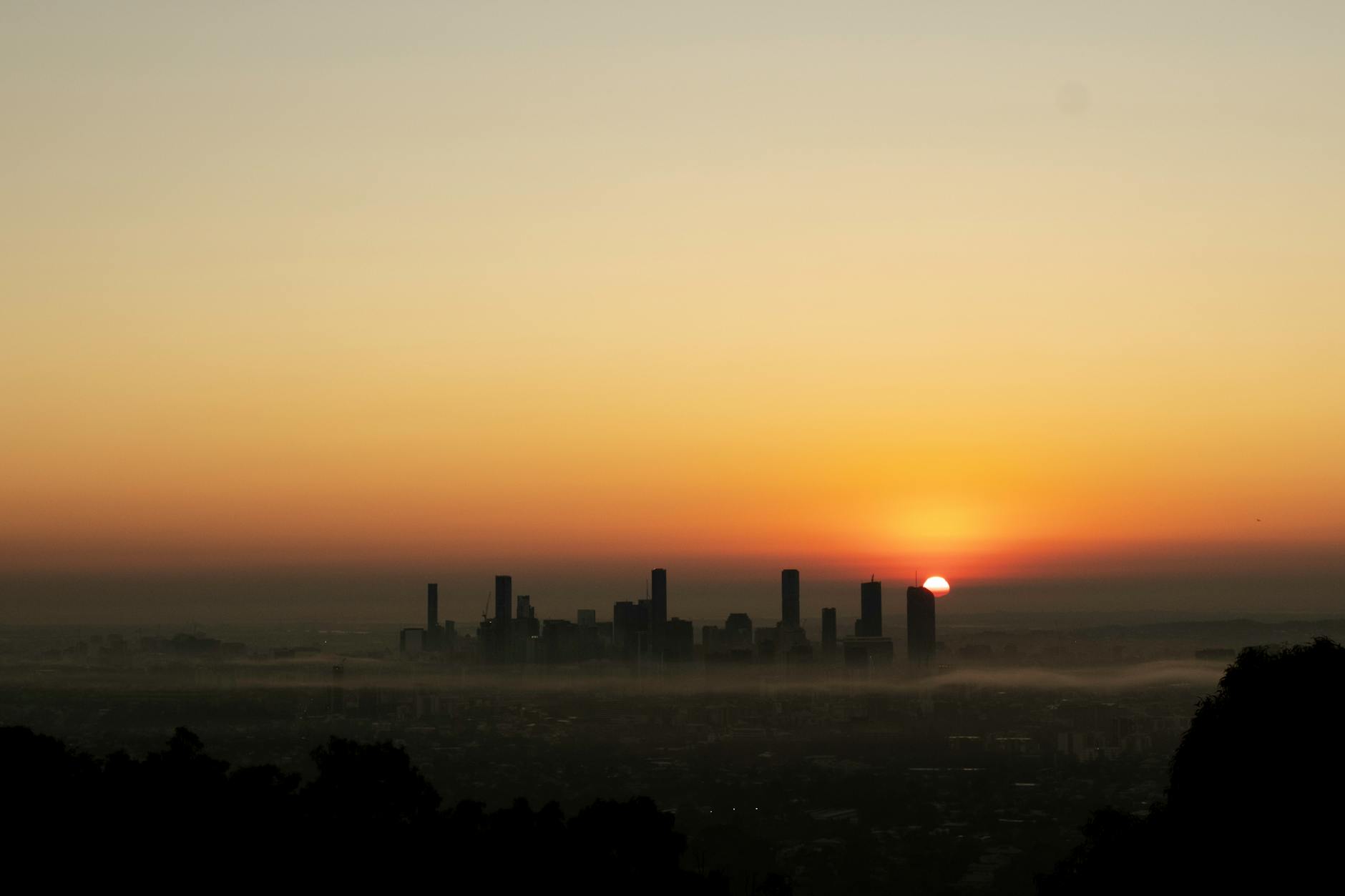 Brisbane sunrise skyline for conference transfer and timing planning.