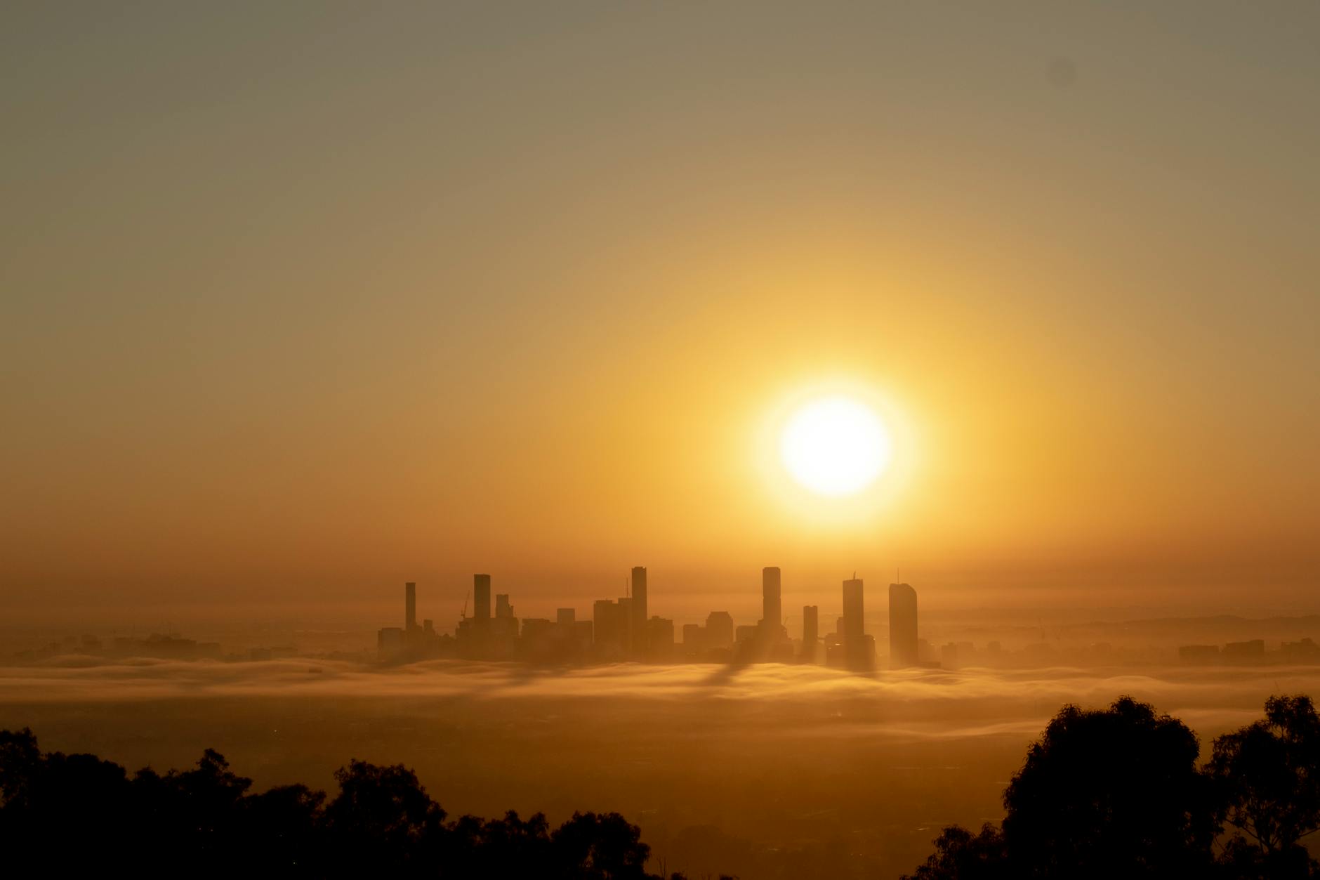 Foggy Brisbane sunrise skyline for conference work and recovery planning.