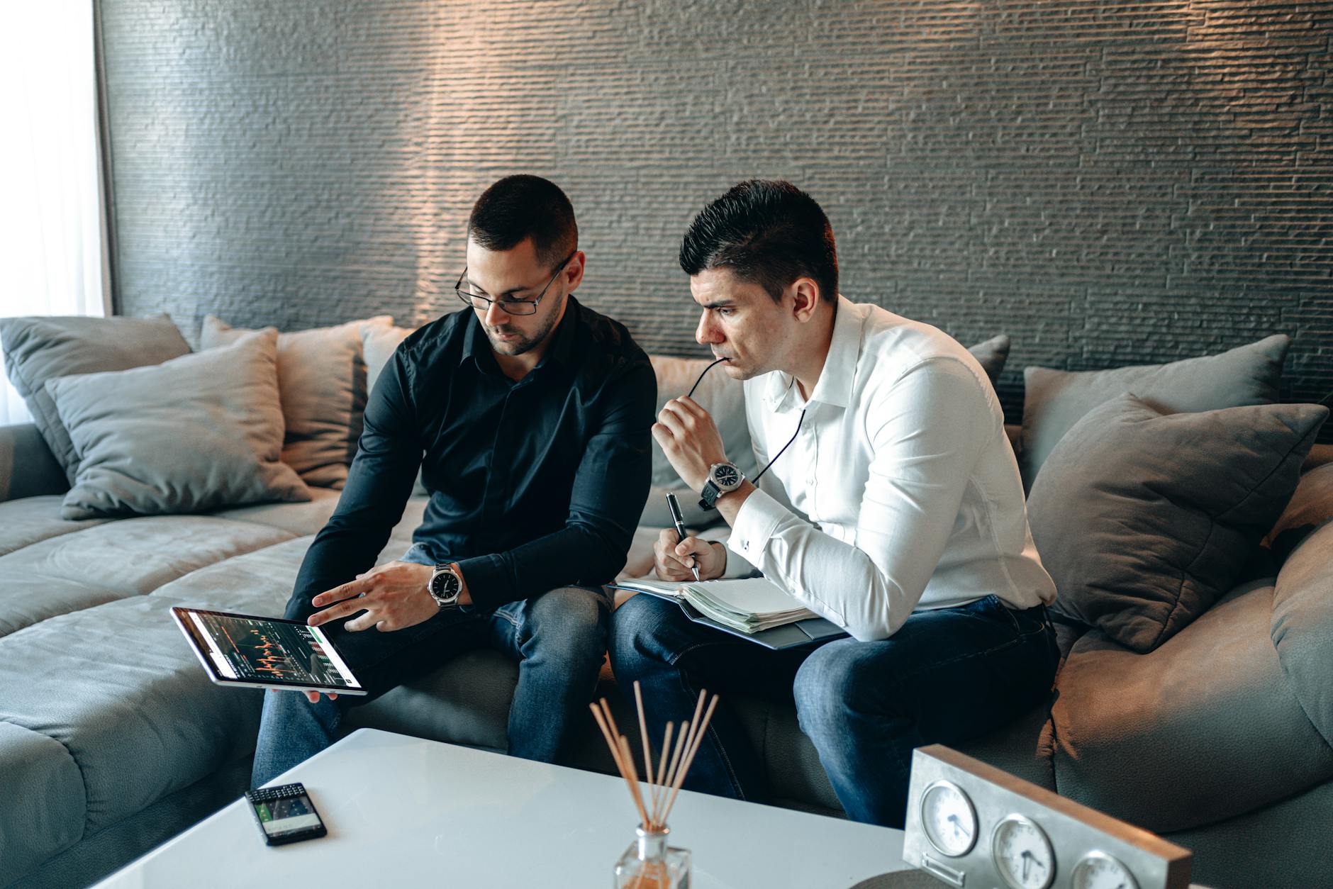 Business professionals reviewing data on a tablet for Brisbane consulting preparation.