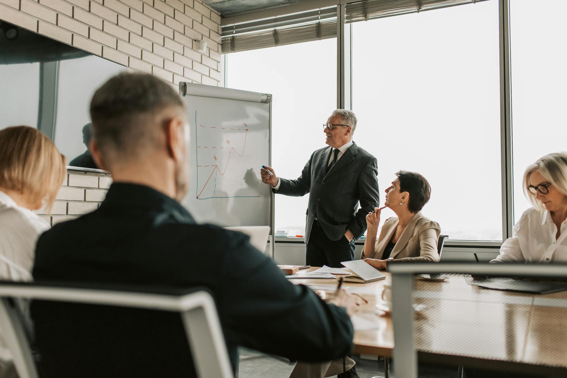 Business leader presenting charts for Brisbane consulting report planning.