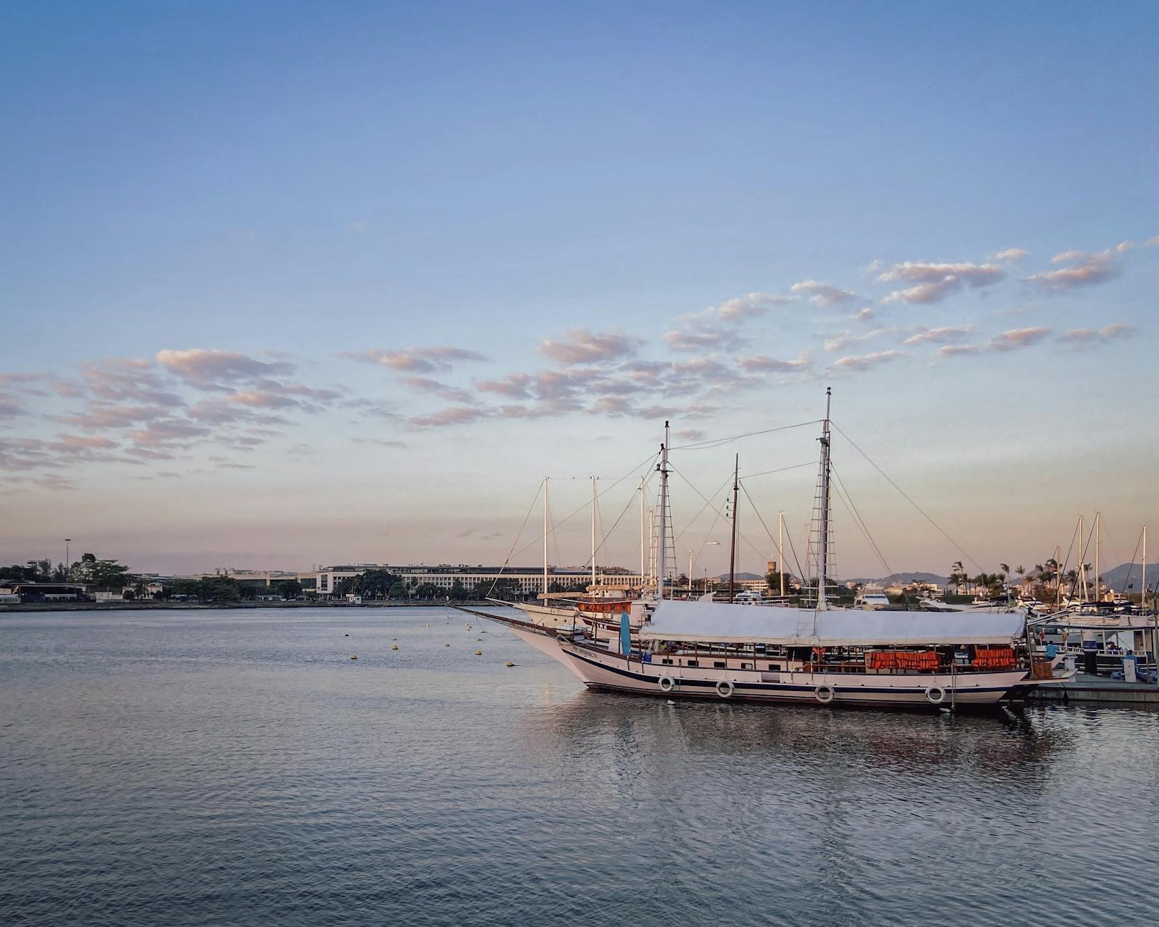 Urban harbor with moored ships for Brisbane port-call meal planning.