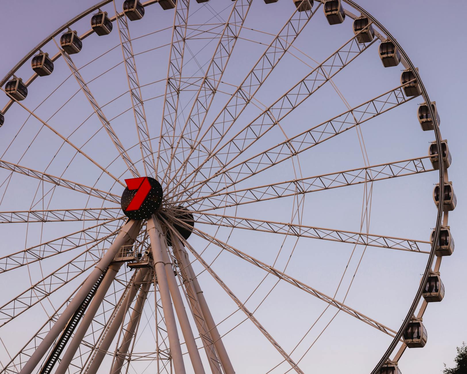 Brisbane Ferris Wheel against sunset sky for family lodging area planning.