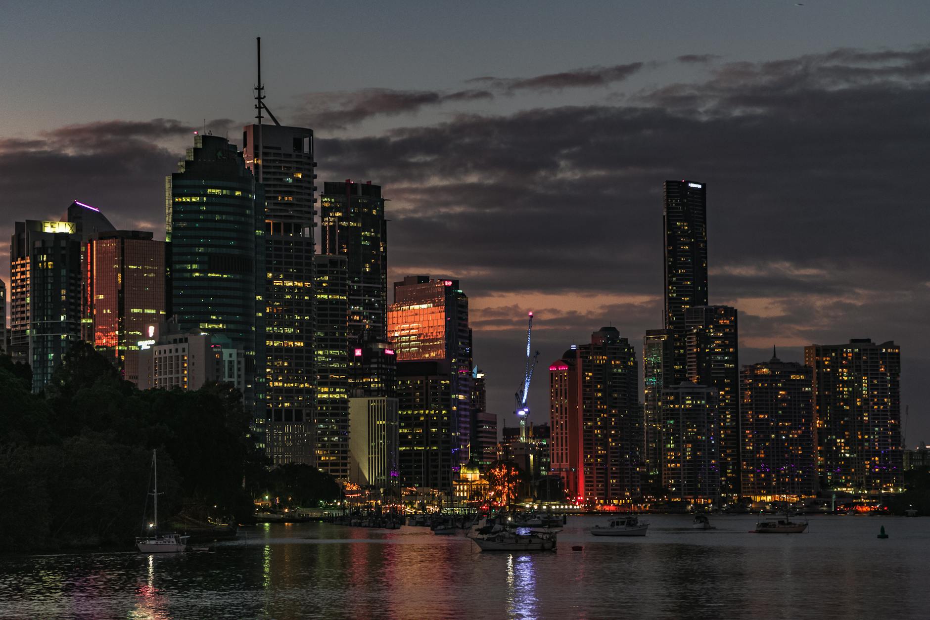 Brisbane skyline at sunset over the river for luxury travel planning.