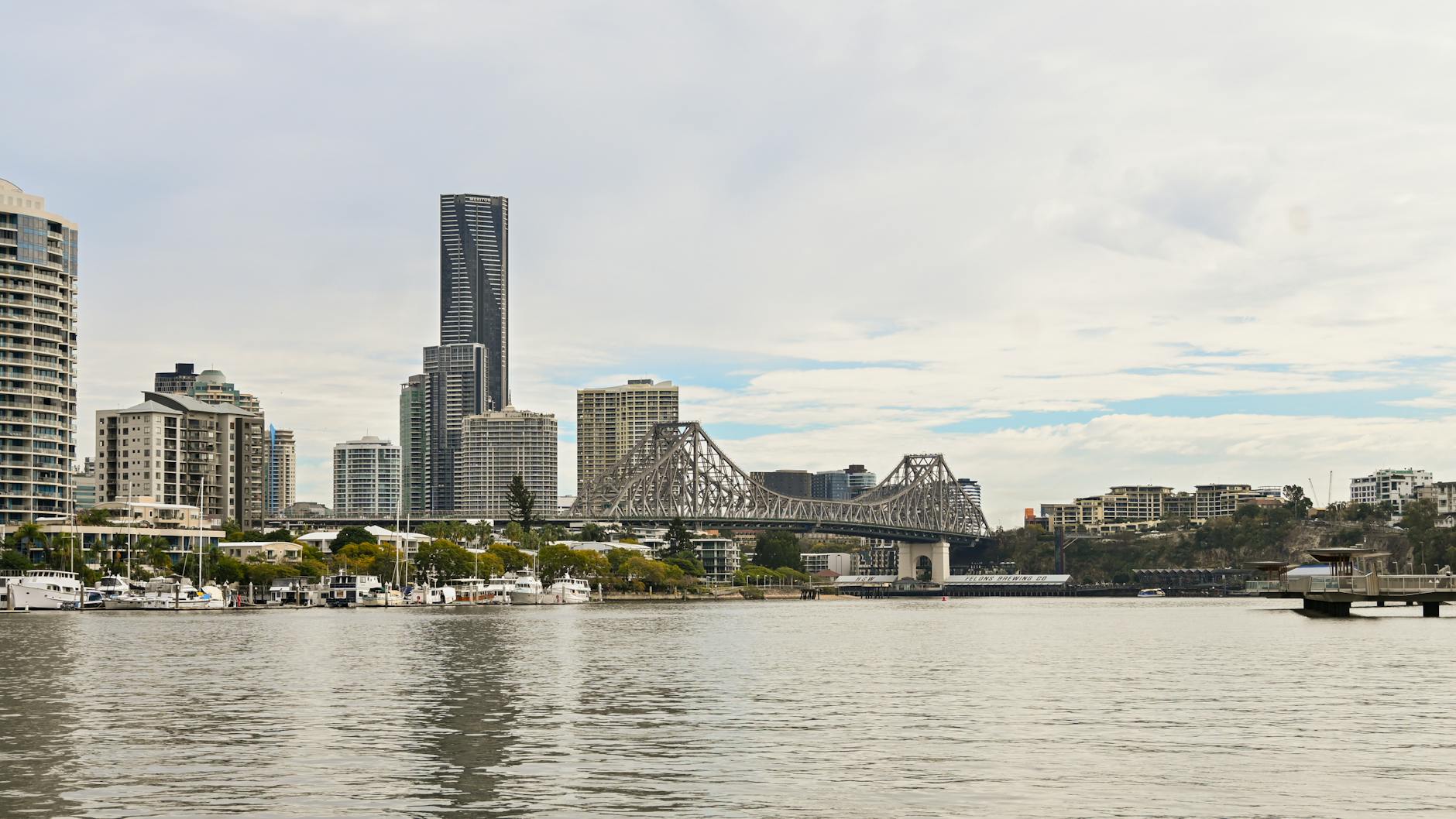 Brisbane skyline and bridge reflections for luxury travel report planning.