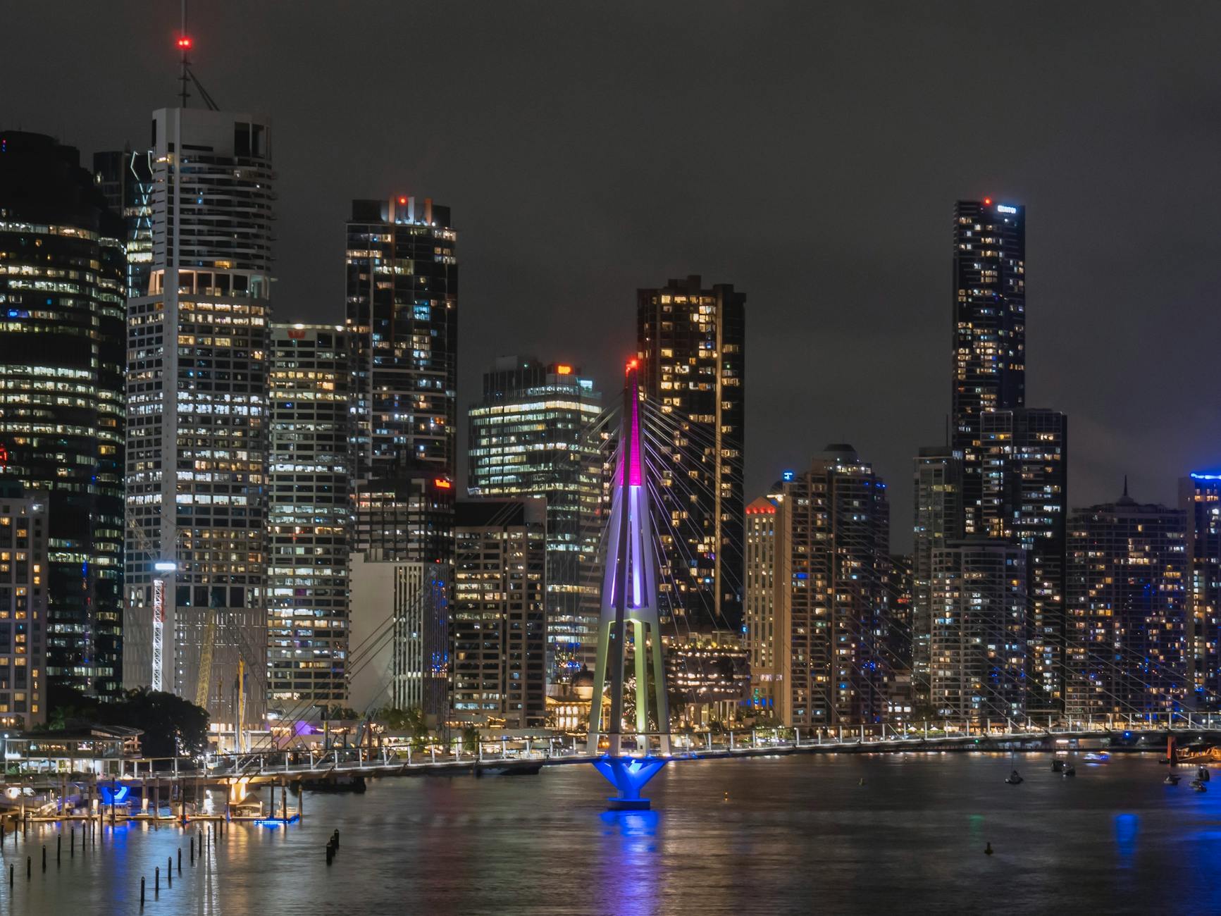 Brisbane illuminated skyline and bridge for luxury dining planning.