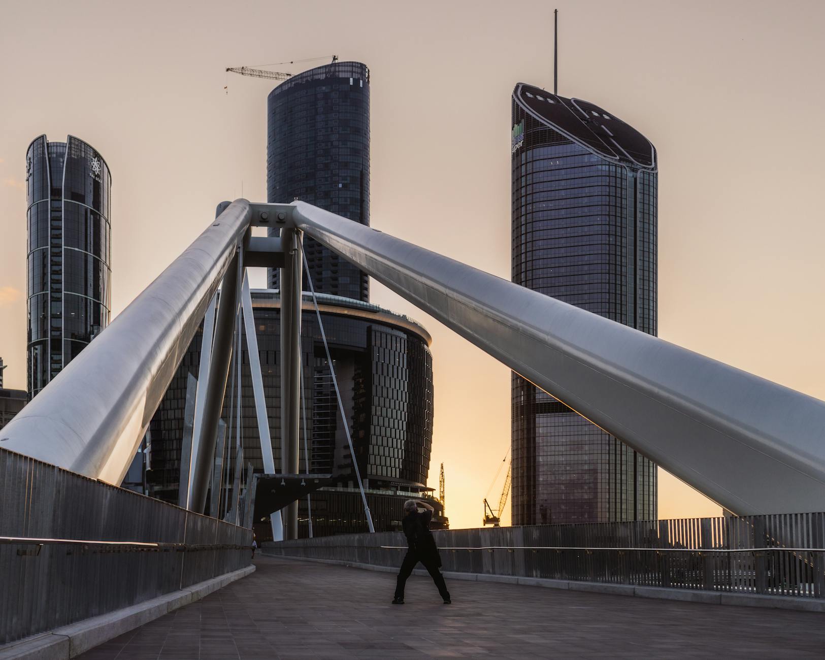 Pedestrian bridge and Brisbane skyline for predictable movement planning.
