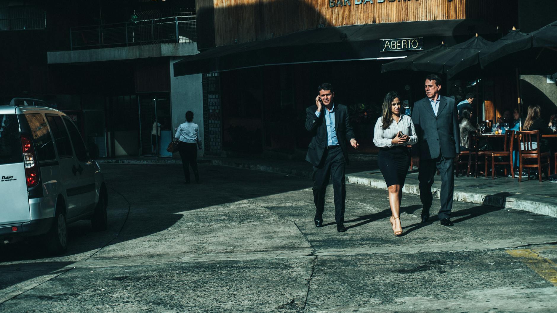 Business travelers outside a cafe for Brisbane sales report planning.