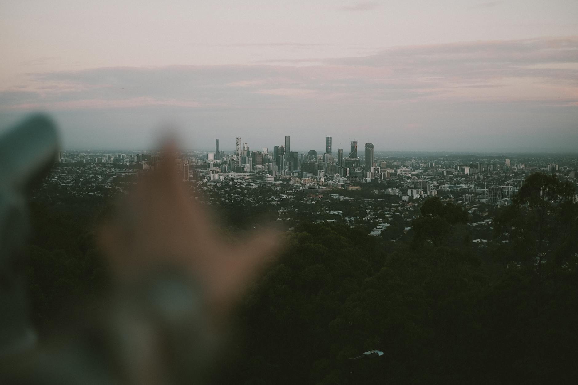 Soft-focus Brisbane skyline at twilight for solo weather planning.