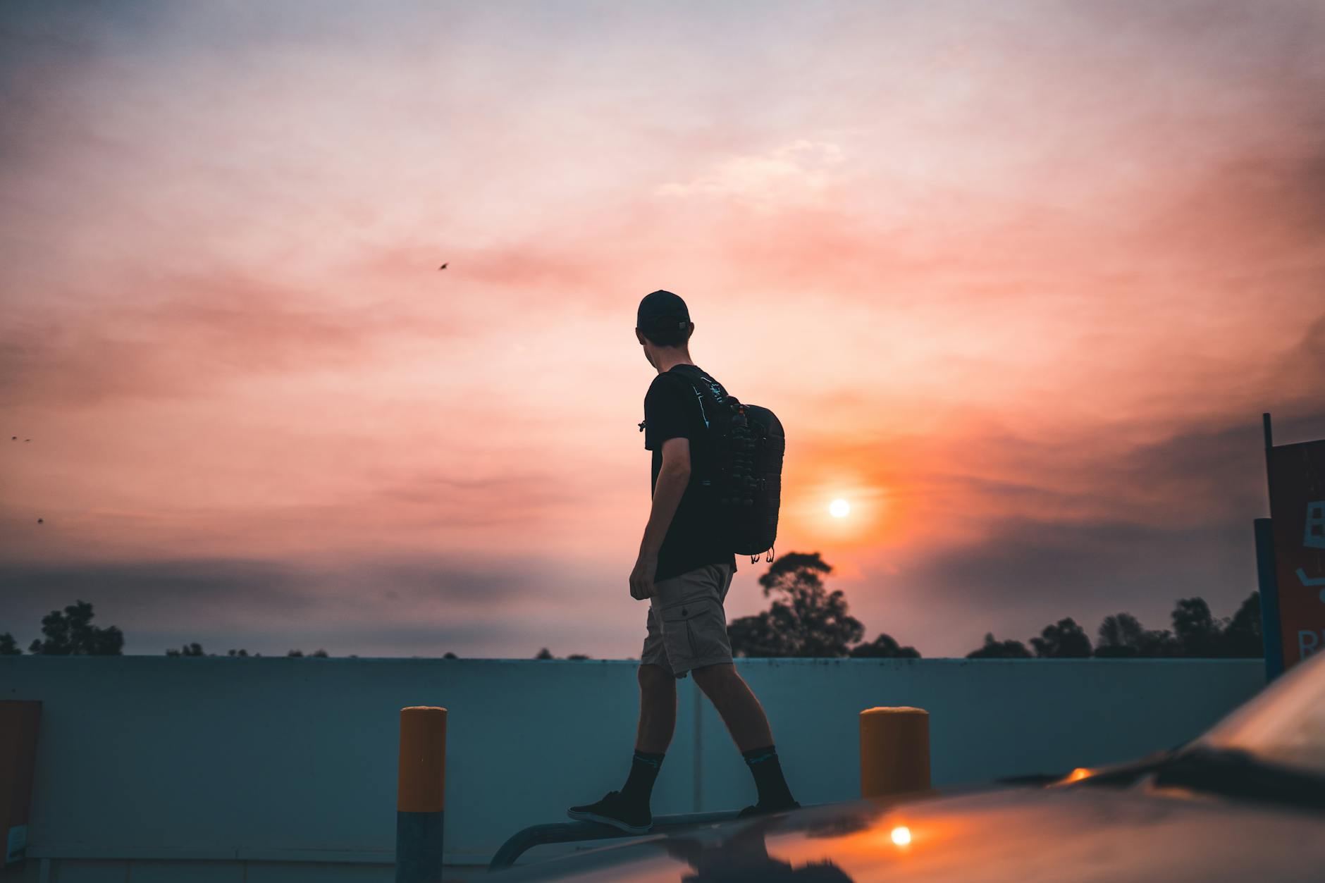 Backpacker walking at sunset in Brisbane for tourist orientation planning.