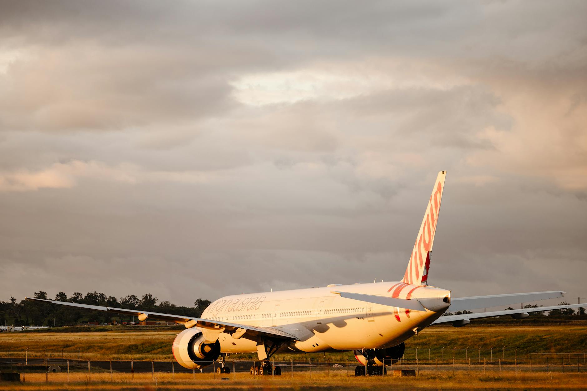 Virgin Australia aircraft on a Queensland airport tarmac for Brisbane stopover planning.