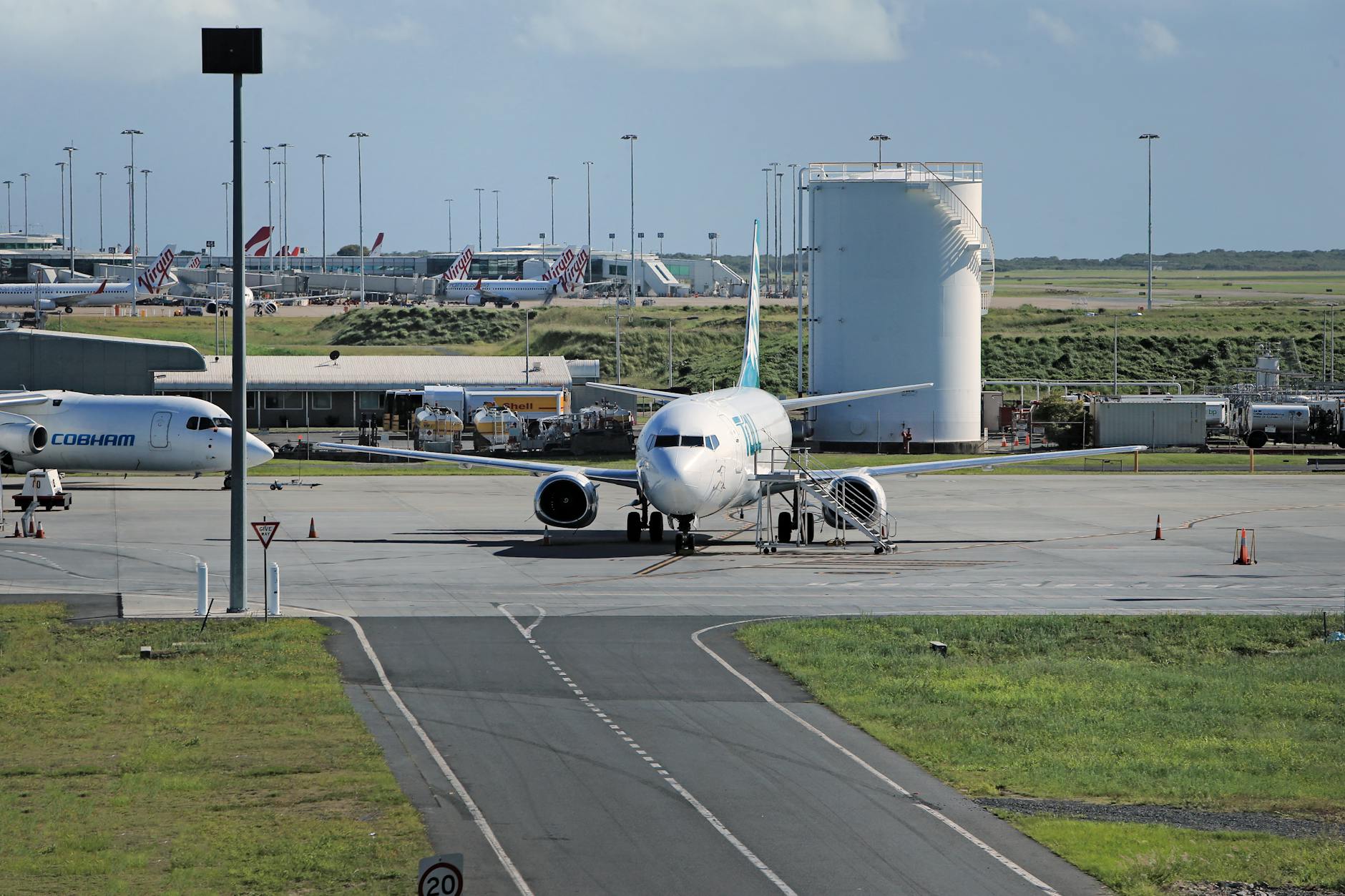 Airport taxiway with parked airliners for Brisbane stopover transfer planning.
